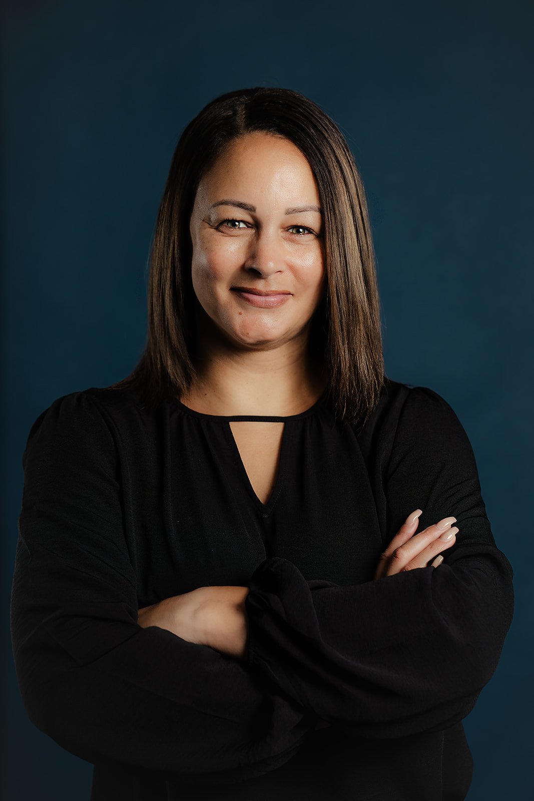 A headshot photo of Erica Harris smiling, conveying professionalism and warmth.