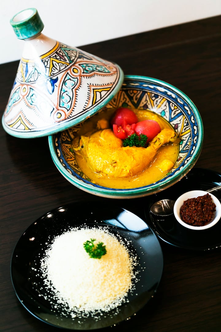 Classic Moroccan chicken tagine with Couscous on the wooden table