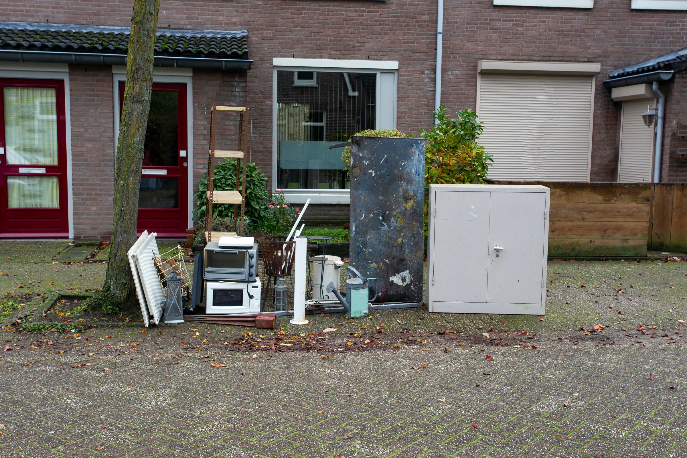Old olectronic waste and other iron things ready for pick up for recycling, bulky waste in a street close-up