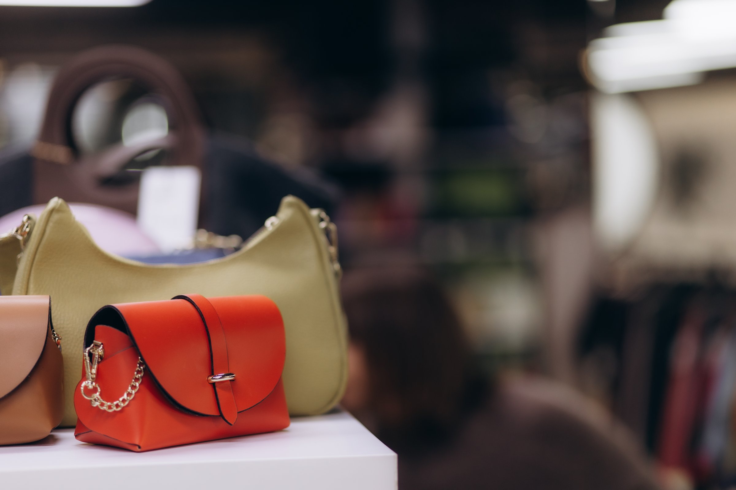 Vibrant collection of handbags on a display shelf in a stylish boutique