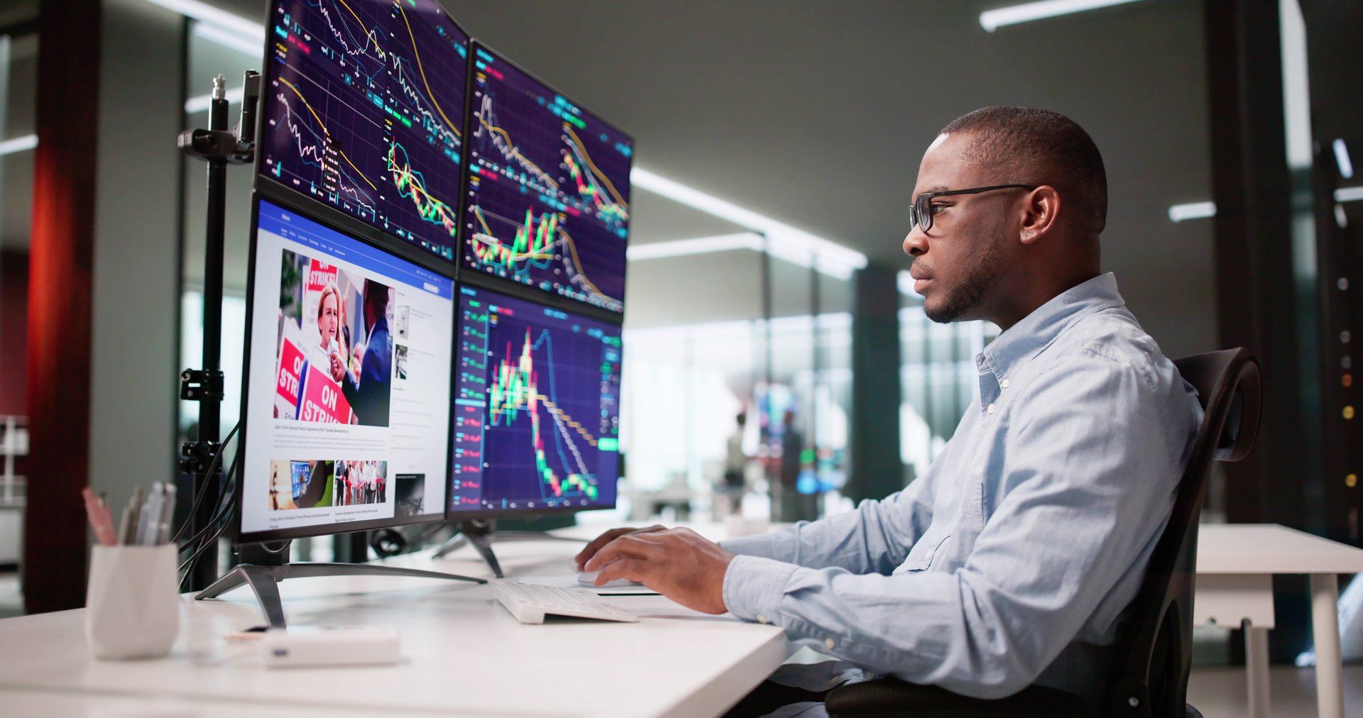 African American Man Trading Stocks Online At Desktop Computer Screen