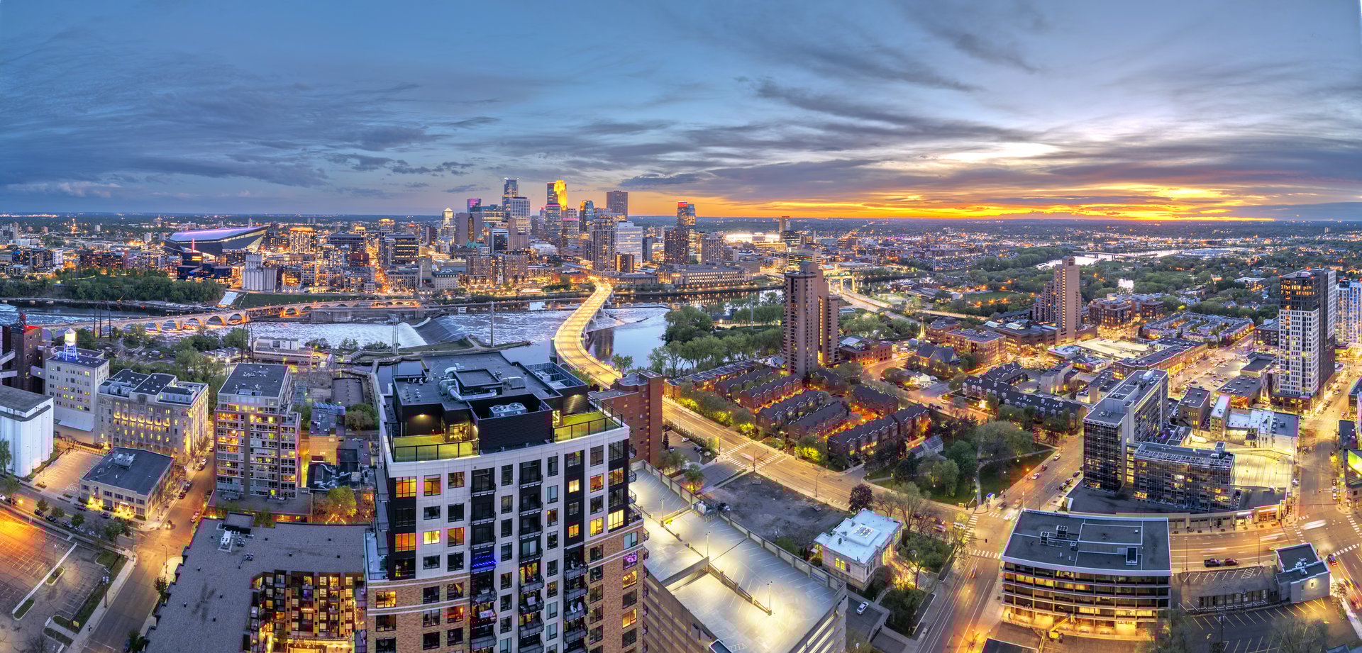 Minneapolis, Minnesota, USA downtown city skyline over the river at dusk.