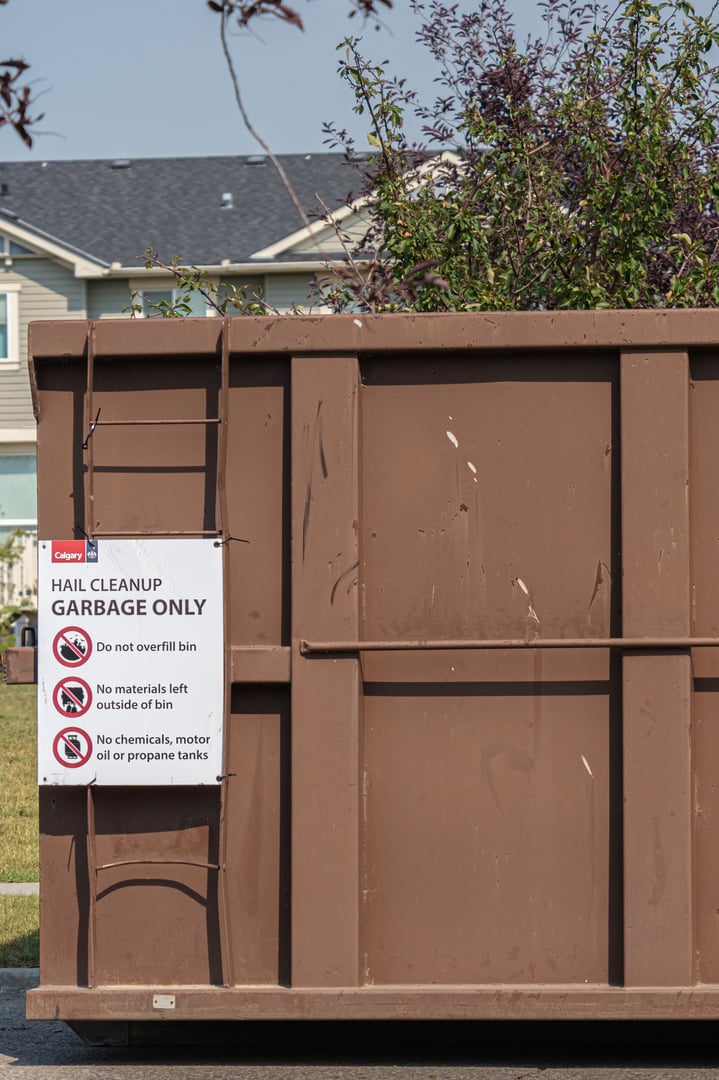 August 23 2024 - Calgary Alberta Canada - Garbage Dumpster to collect hailstorm Cleanup