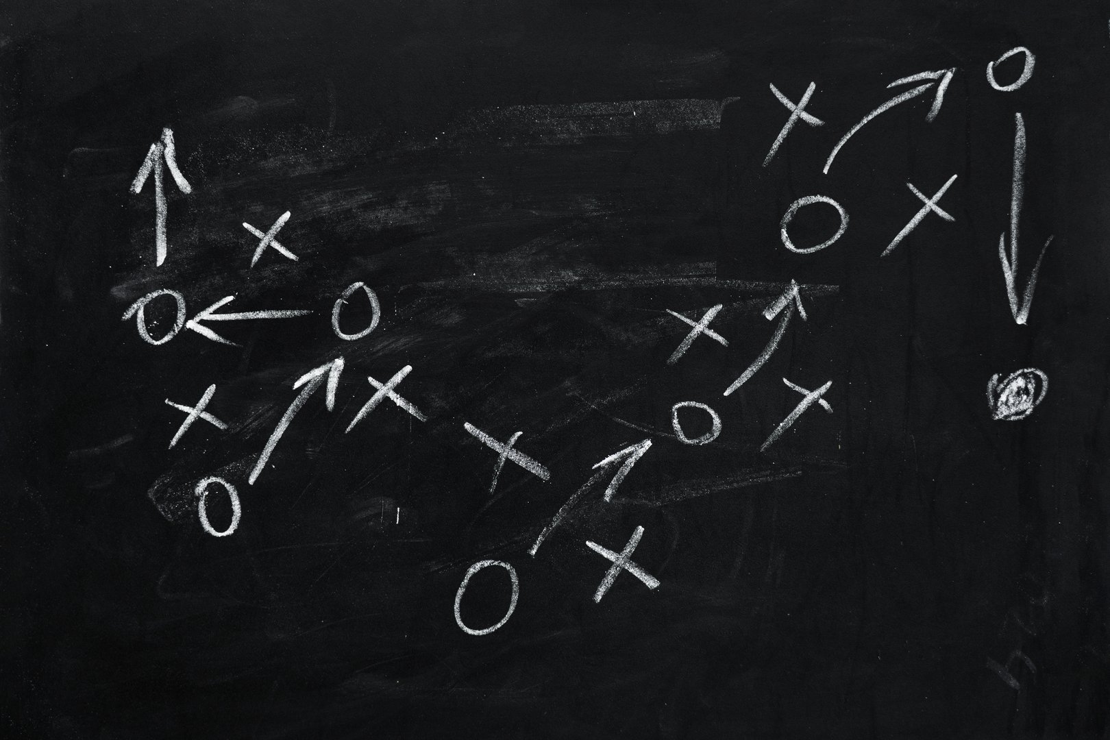 Tactic plan. Hand drawn arrows as strategy scheme sketch, isolated on on the black chalkboard. Business or sport succes concept.