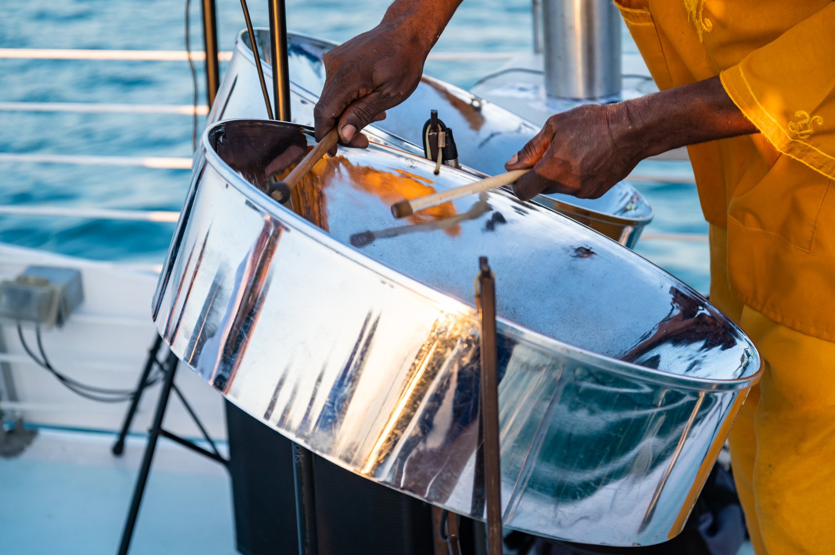 Close up of a a musician from Jamaica playing steel pan drums on the open deck of a tourist boat in Key West, Florida.
