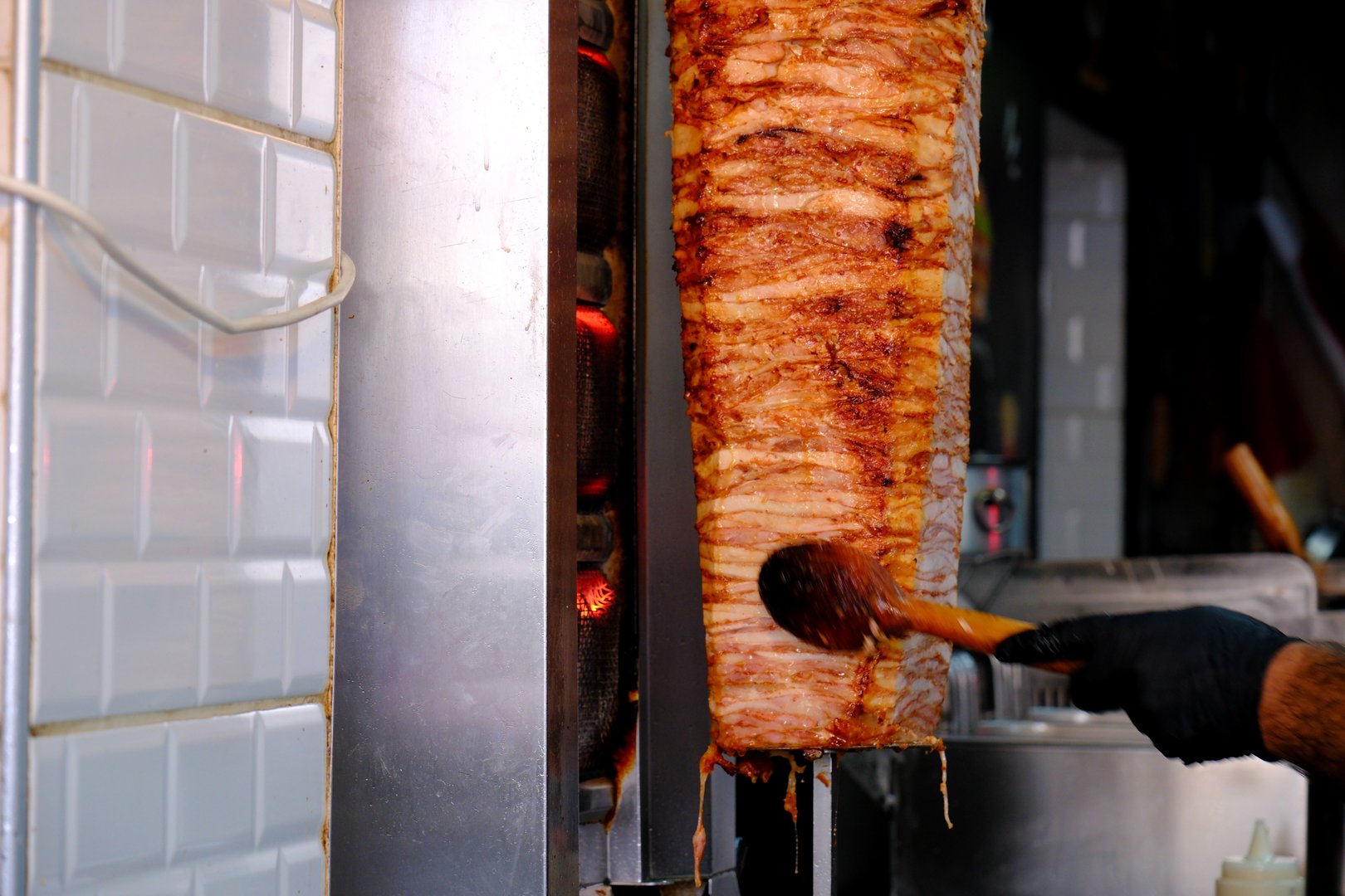 Photo of the famous Turkish street delicacy chicken doner while it is cooking. Turkish food. Turkish cuisine. Food industry.