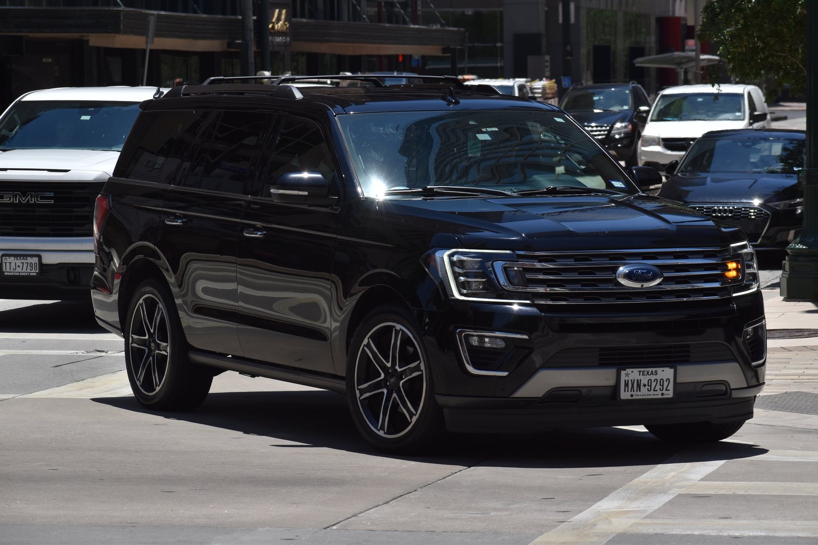 Houston, TX USA - May 15, 2024 - A portrait of a black Ford Expedition SUV cruising in a downtown district