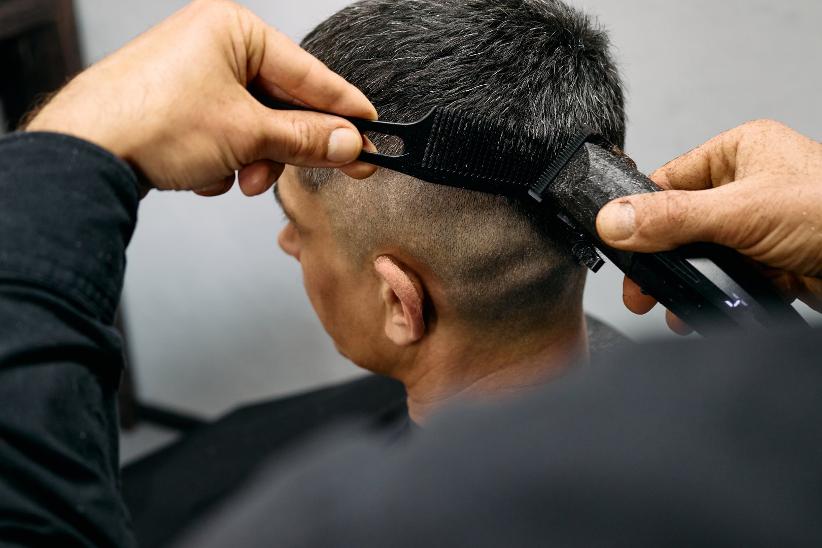 Professional barber creating a smooth fade haircut