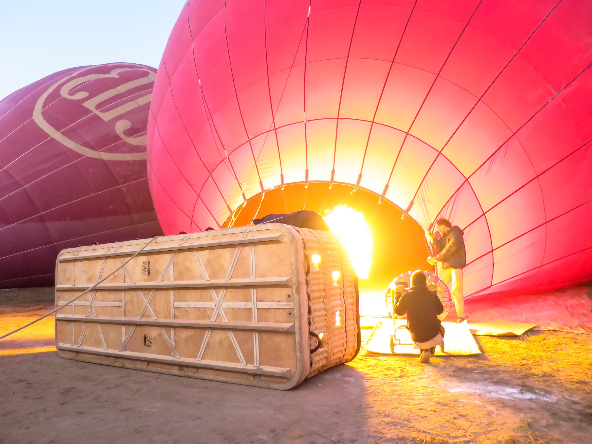 Bagan, Myanmar - January 26, 2015: Balloons Over Bagan using bright fire flame for hot air inflation process on ground.