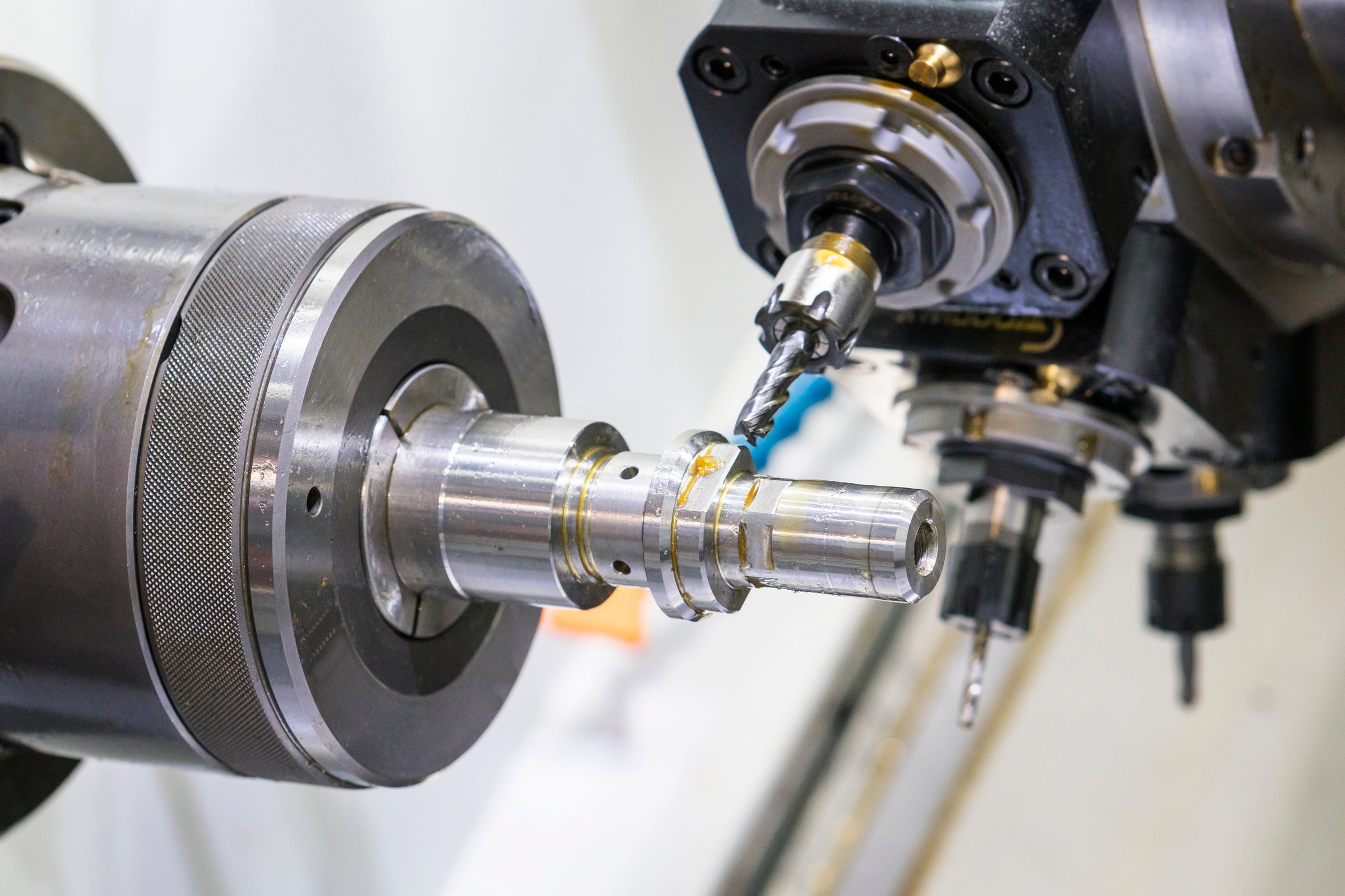 Operator machining automotive part by cnc turning machine, Multi axis CNC turning and milling machine, High precision part manufacturing process with milling by endmill carbide