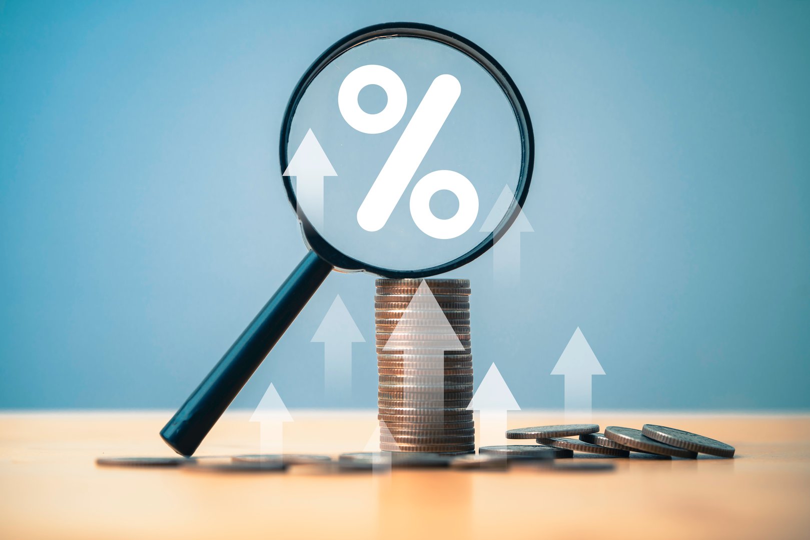 Coins money stacking with up arrow and percentage symbol inside magnifier glass for financial banking increase interest rate or mortgage investment dividend from business growth concept.