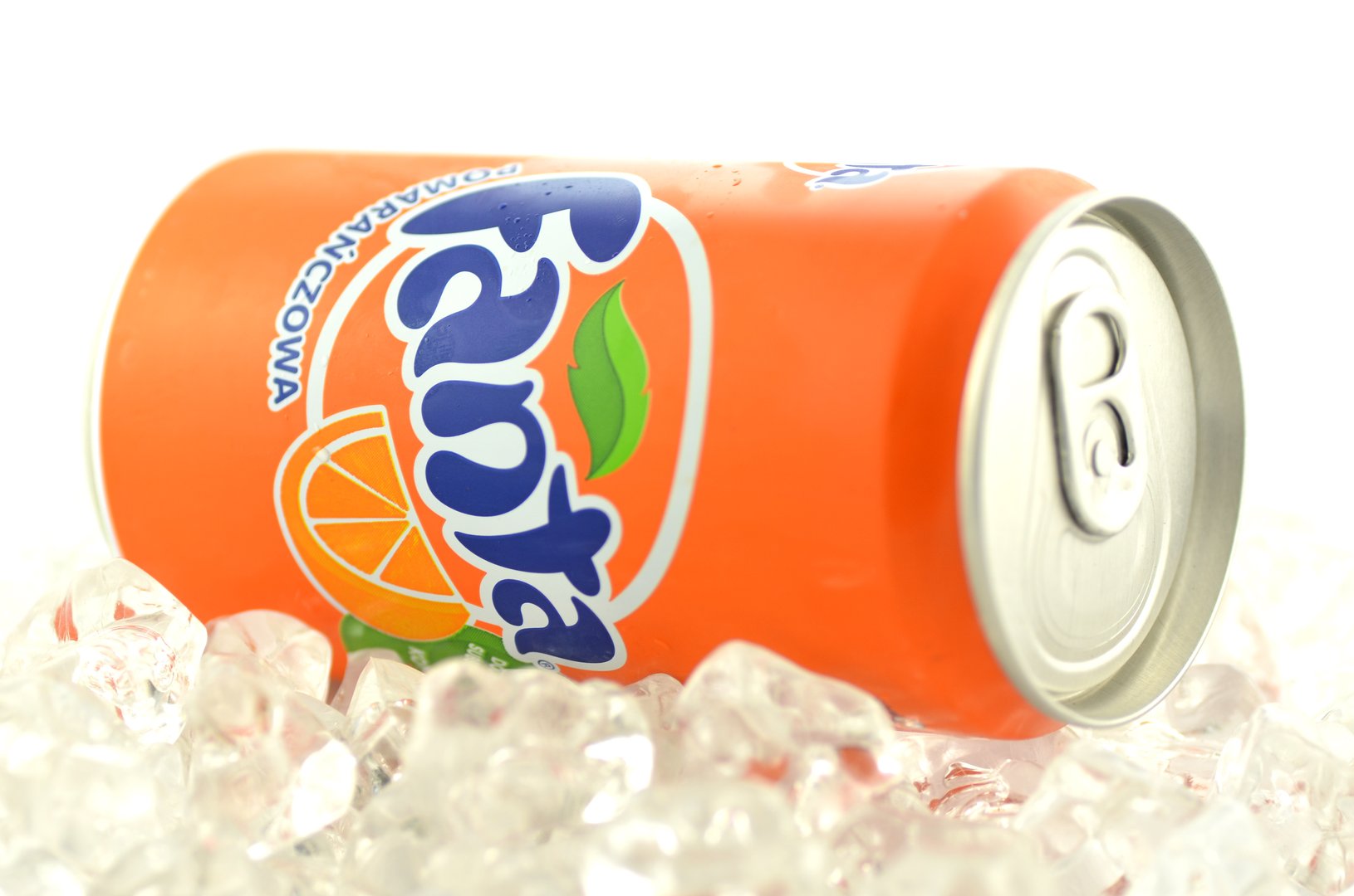 Kwidzyn, Poland - March 11, 2014: Fanta drink in a can on ice isolated on white background. Fanta is fruit-flavored carbonated soft drink produced by Coca-Cola Company. Fanta was introduced in 1941