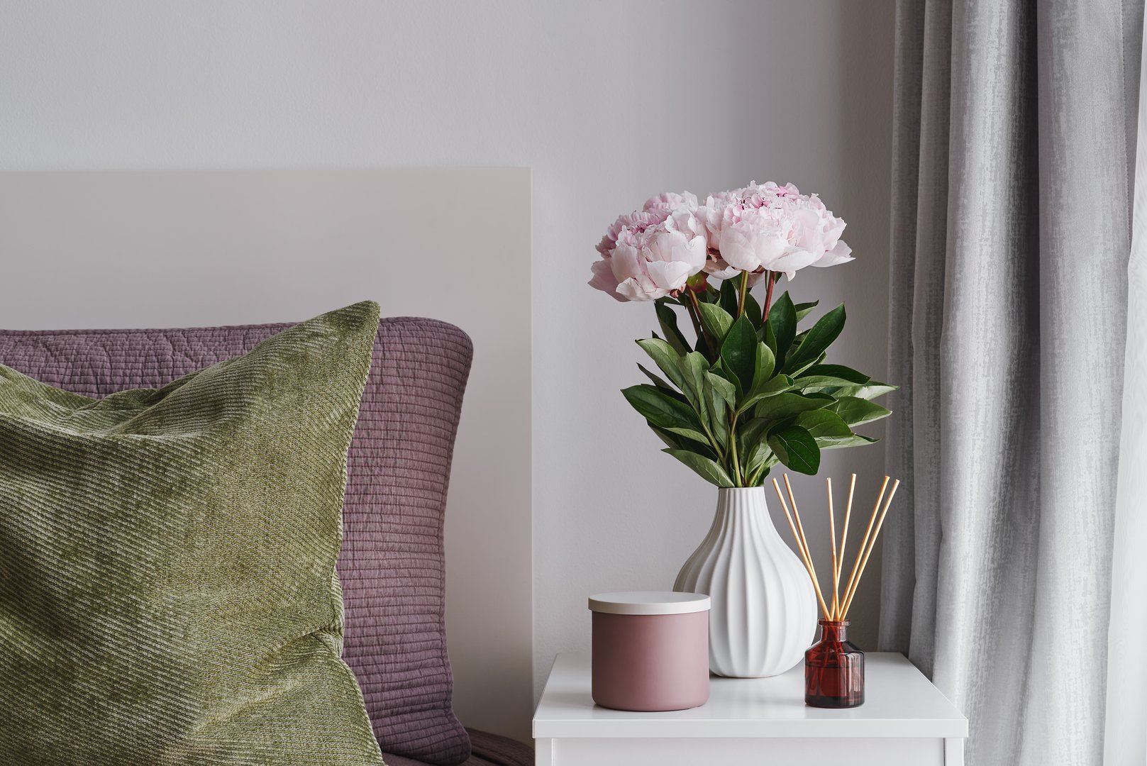 Bedroom Decor: Fresh Pink Peonies in a White Ceramic Vase, Scented Candle, Reed Diffuser and Cushions