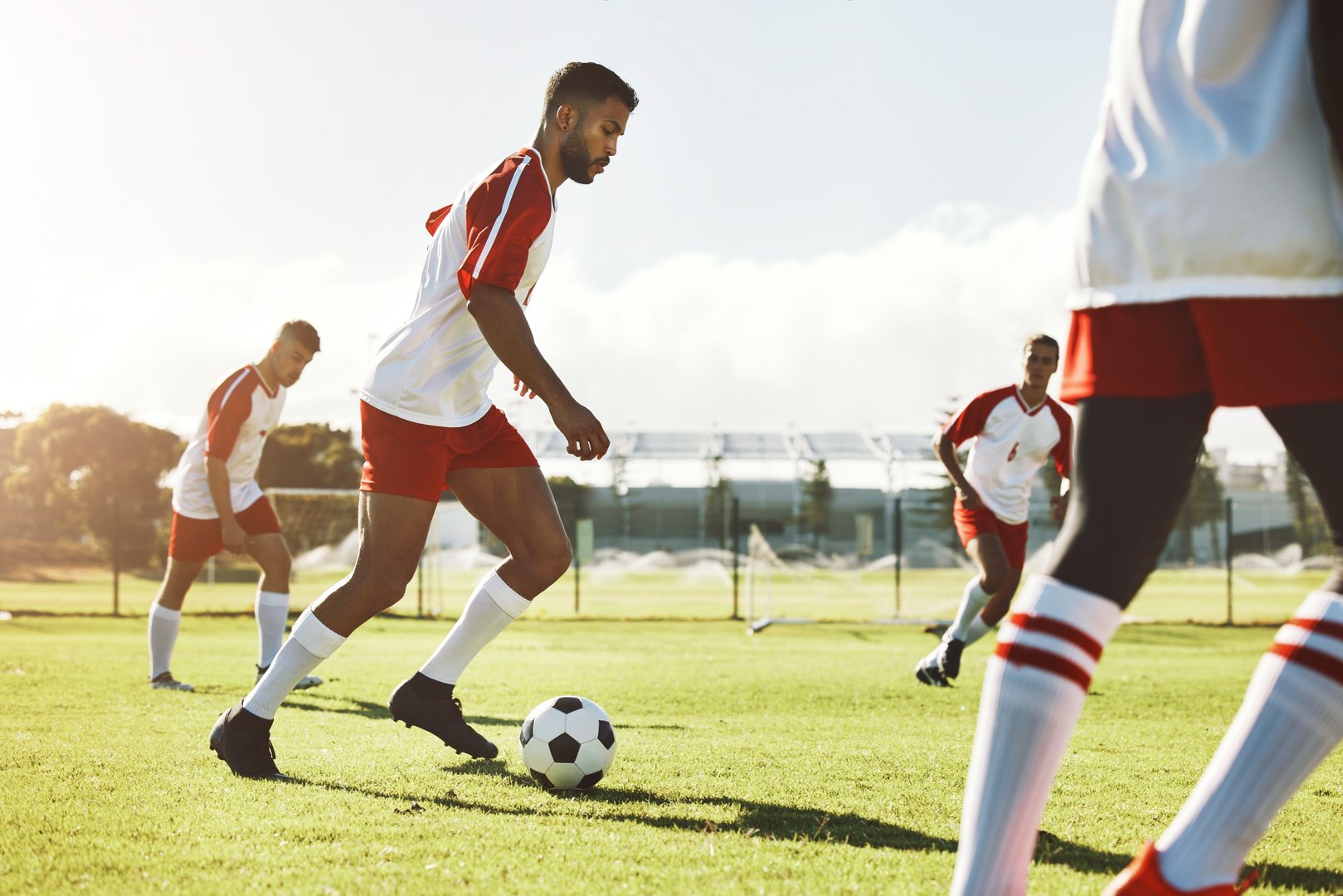 Team sports game, soccer and teamwork of men busy with football collaboration and workout. Fitness, training and healthy exercise of an healthy athlete ground with fast energy running with a ball