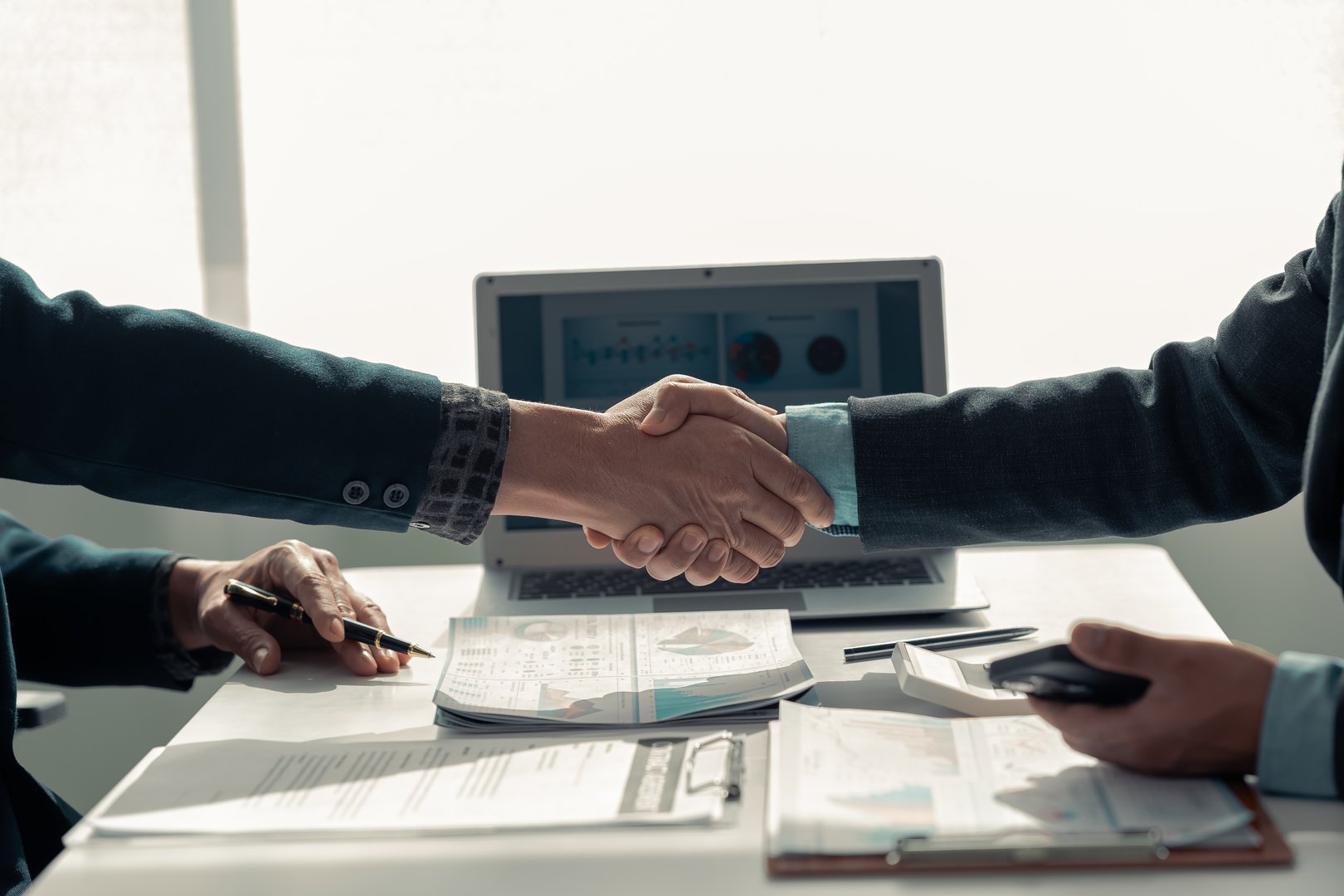 business people shaking hands End of meeting, business etiquette, merger concept Completing the meeting to sign the agreement and establish the partnership Contracts for both companies Close-up photo