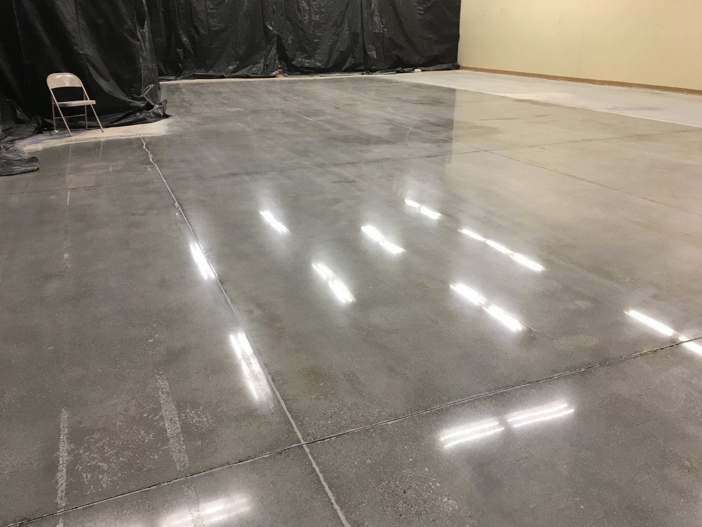 Shiny Fluorescent Light Reflections on Newly Polished Concrete Floor . High quality photo