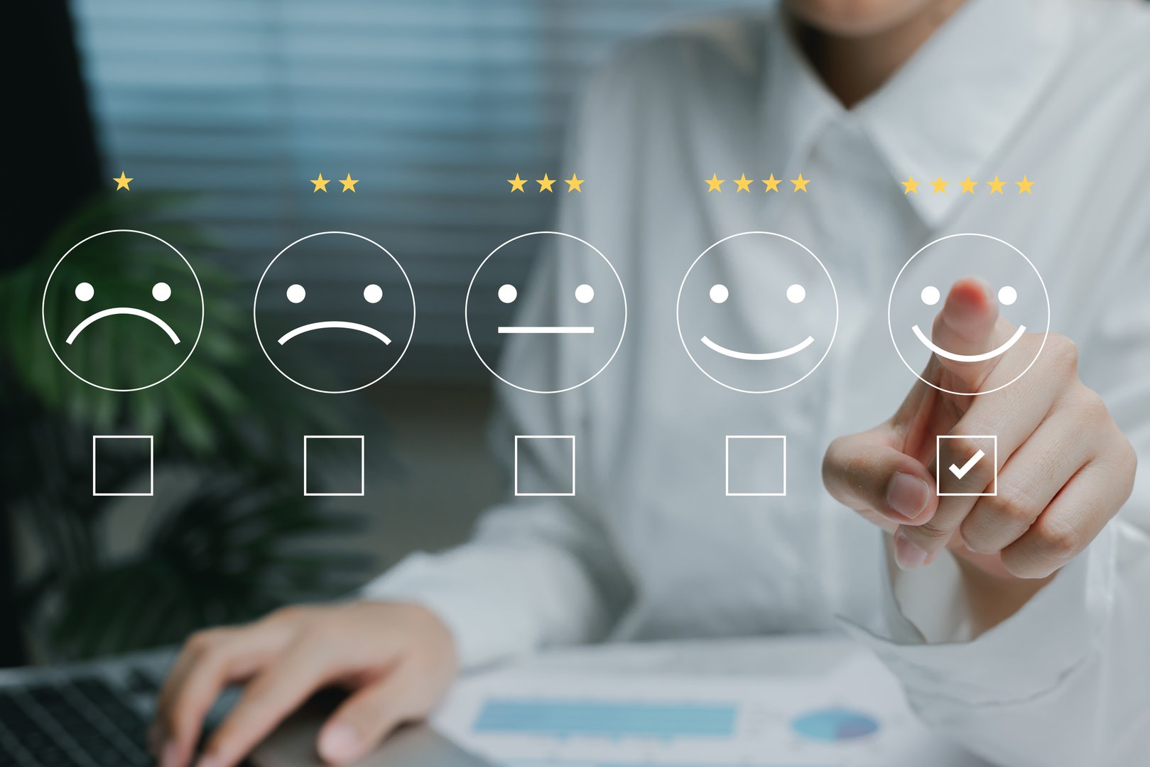 Customer satisfaction survey concept. Hand selecting five-star rating with emoticons representing levels of service satisfaction.