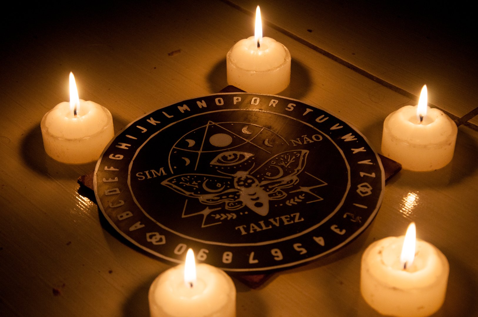 photograph of a ritual with a pendulum board