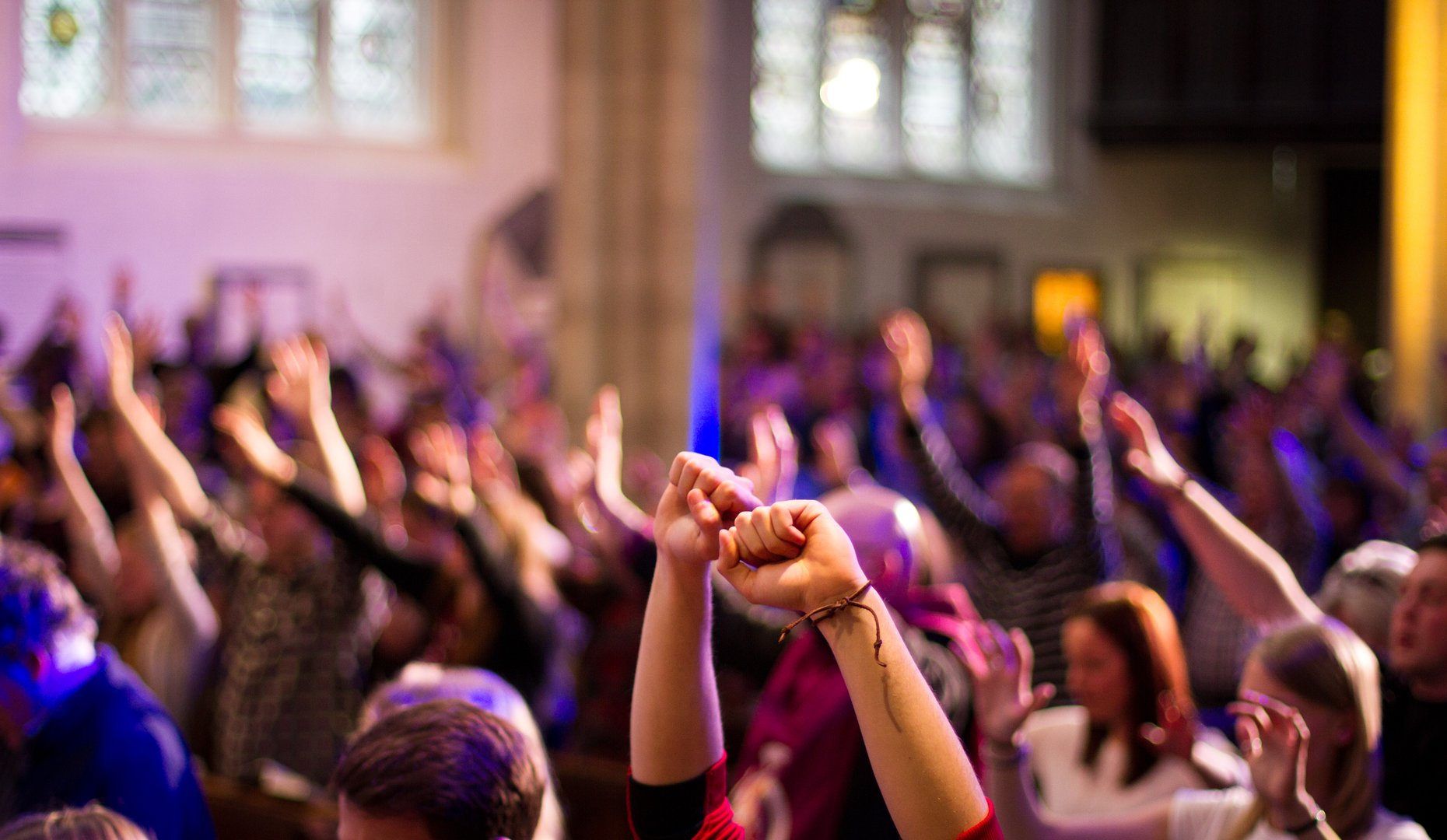 Congregation worship with raised hands at church
