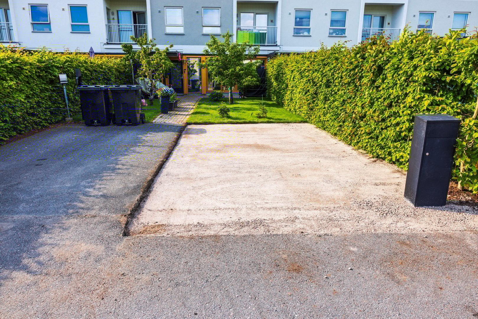 Area for second car parking prepared in front of townhouse as base layer before asphalt paving. Sweden.