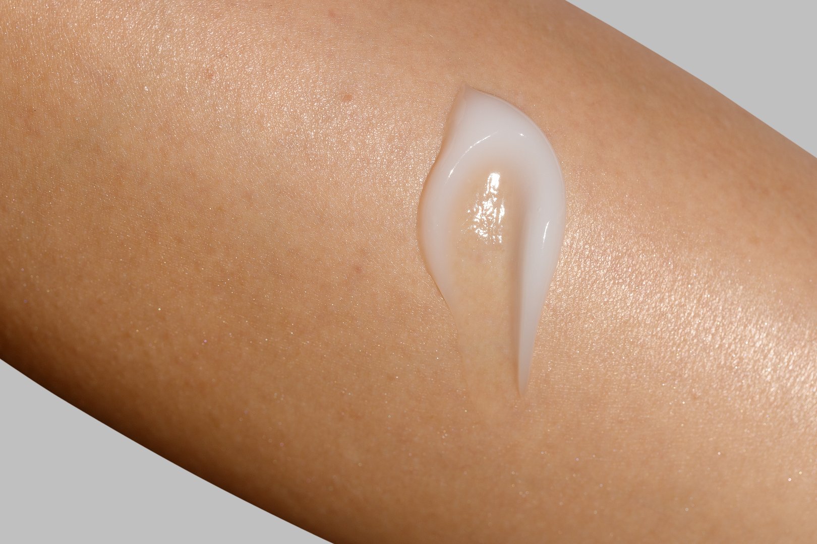 Close-up macro shot of a skincare cream applied on a womans skin. Cosmetic skincare product texture. Face cream, body lotion swipe swatch