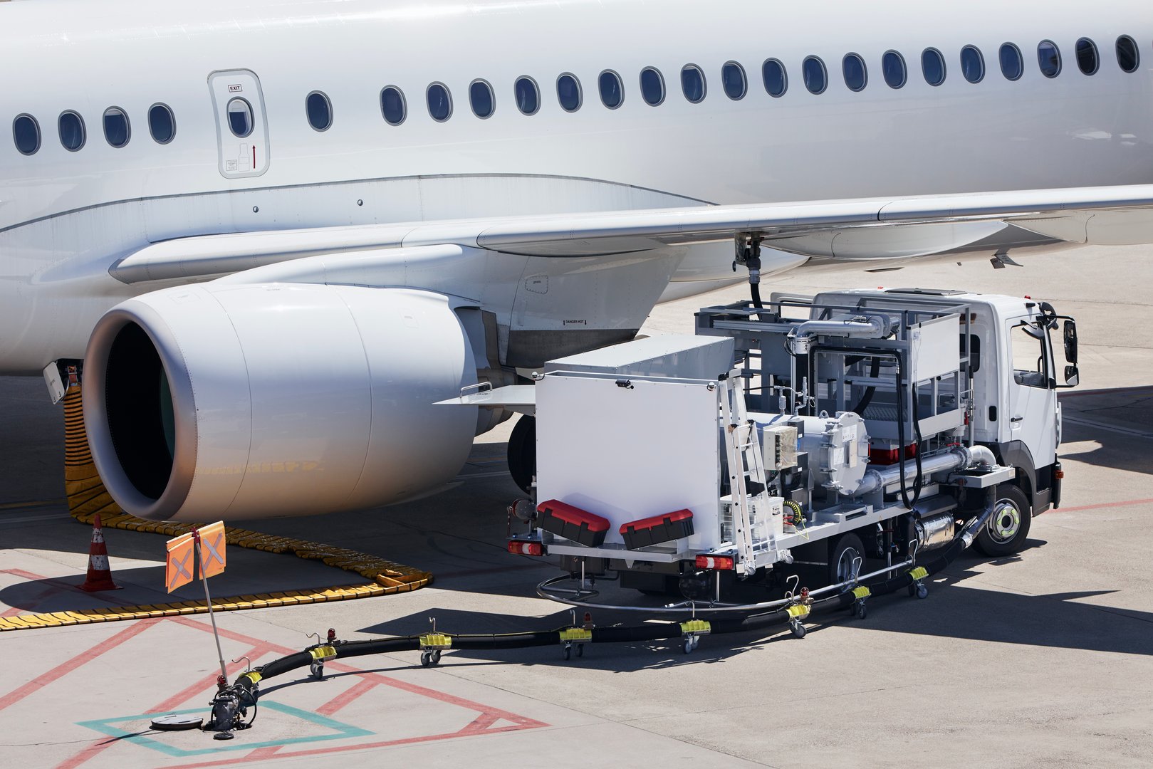 Refueling of airplane at airport. Ground service before flight.