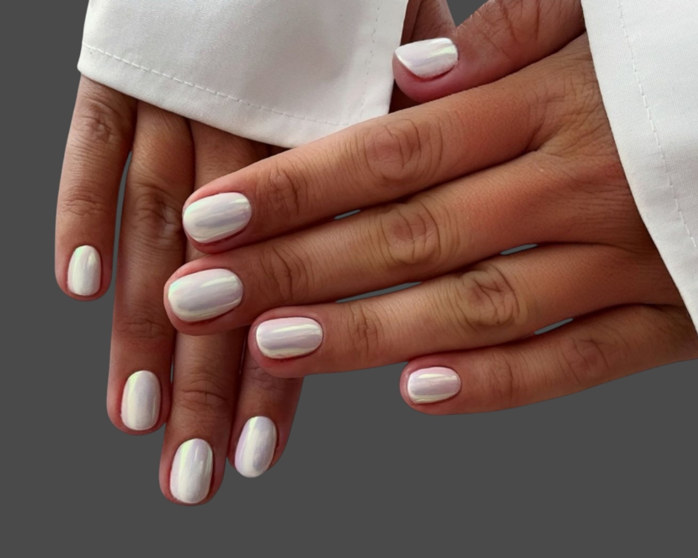 Close-up of a woman's hands showcasing a professional manicure with perfectly shaped nails and glossy polish in a fashionable color. The nail art features intricate and stylish designs that add a touch of sophistication and glamour. Ideal for beauty salons, nail care promotions, cosmetics advertising, fashion editorials, spa treatments, and self-care concepts. The image highlights smooth skin, neat cuticles, and the artistry of modern nail design, making it perfect for marketing campaigns in the beauty and fashion industry