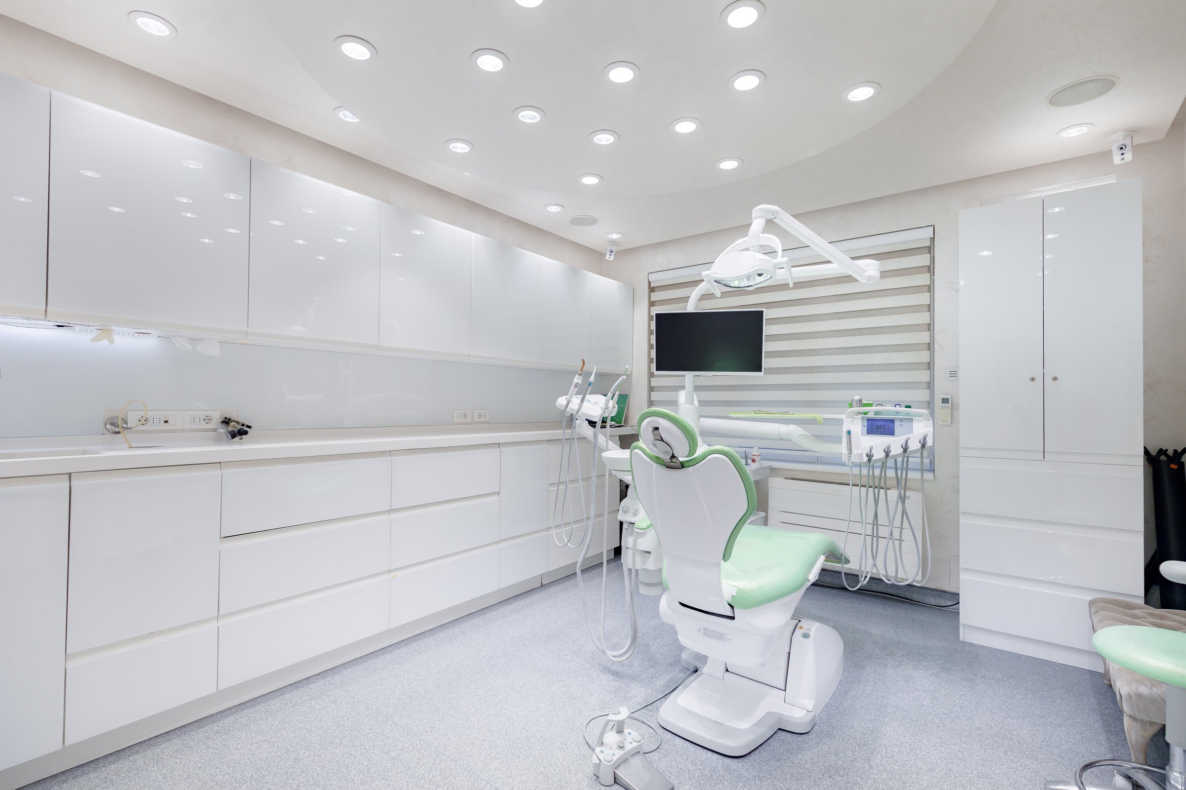 A bright and contemporary dental office features advanced equipment and a welcoming patient chair.