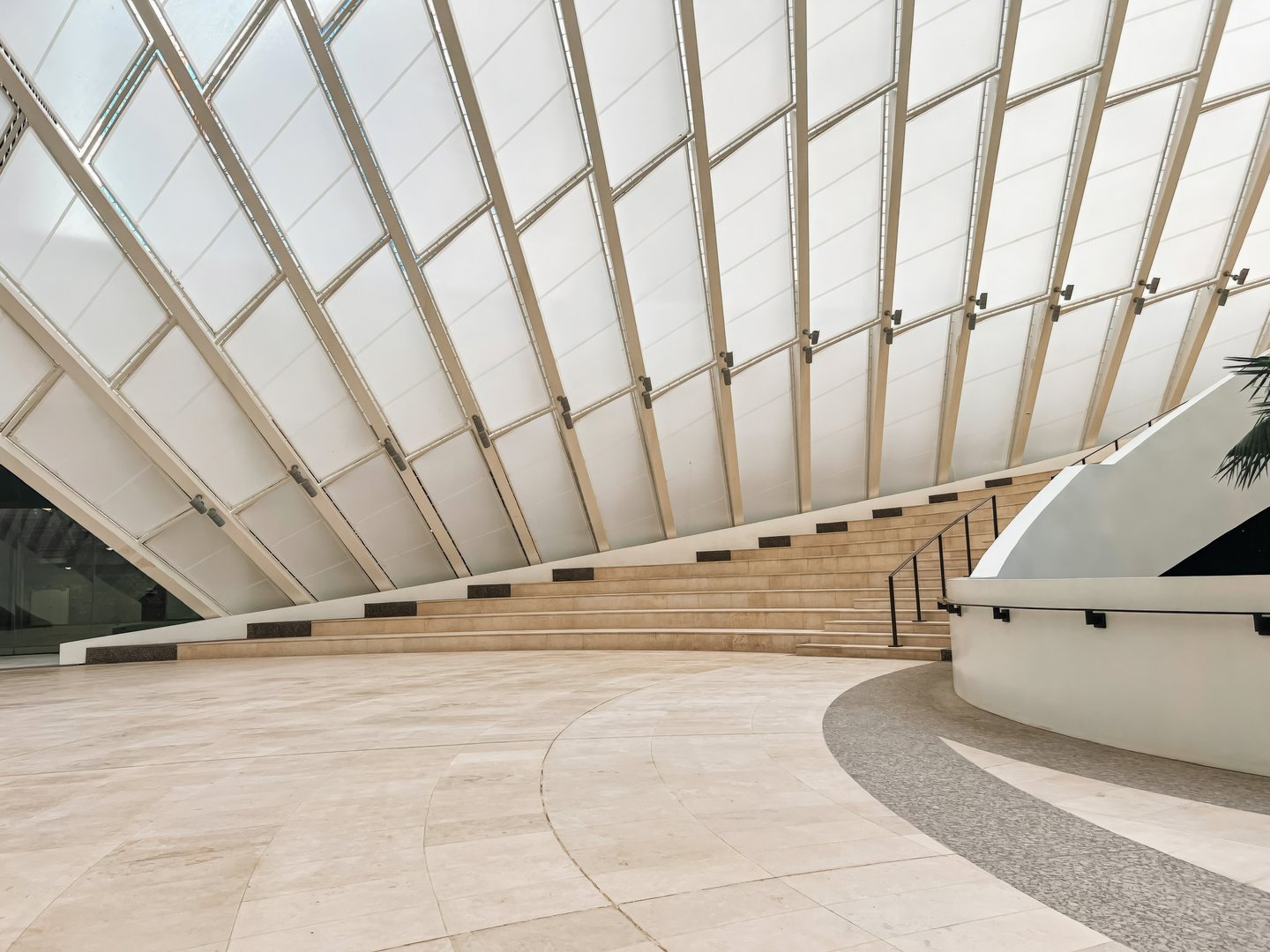 Modern Geometric Architecture at King Abdullah Financial District. A striking geometric architectural design in the heart of King Abdullah Financial District (KAFD), Riyadh, Saudi Arabia. The futuristic facade, made of angular, interwoven shapes, showcases contemporary innovation while reflecting the city's ambition as a global financial hub. The combination of glass, stone, and sharp lines adds to the building's bold aesthetic. High-quality photo