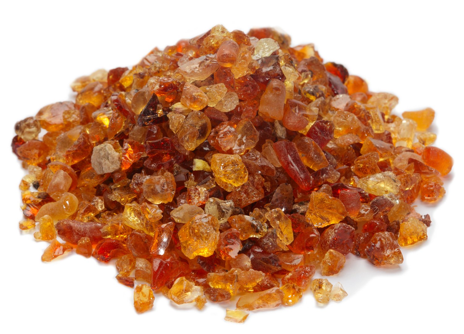 Pile of golden-orange resin crystals with a translucent appearance, varying in size and shape.