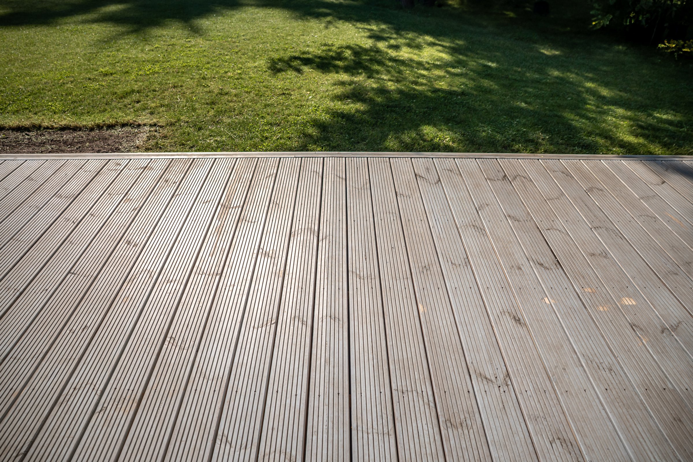 Wooden deck with grass lawn