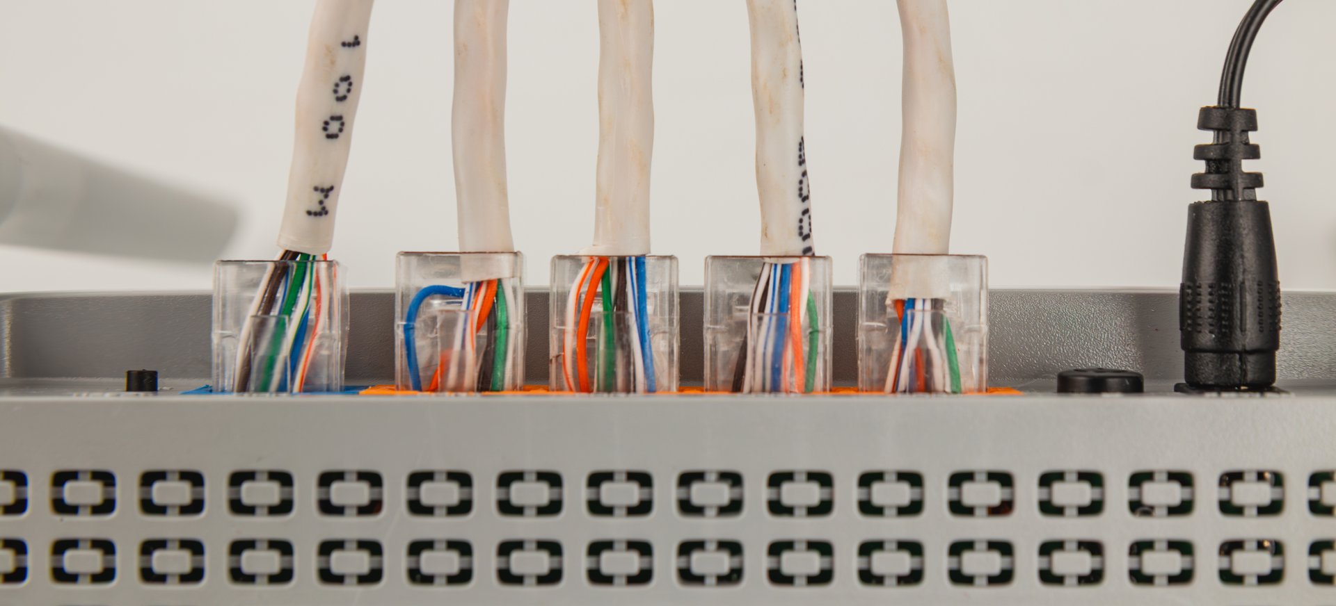 Wires are connected to a network switch, showing colorful RJ45 connectors. This setup is typical in home or office environments for internet connectivity.