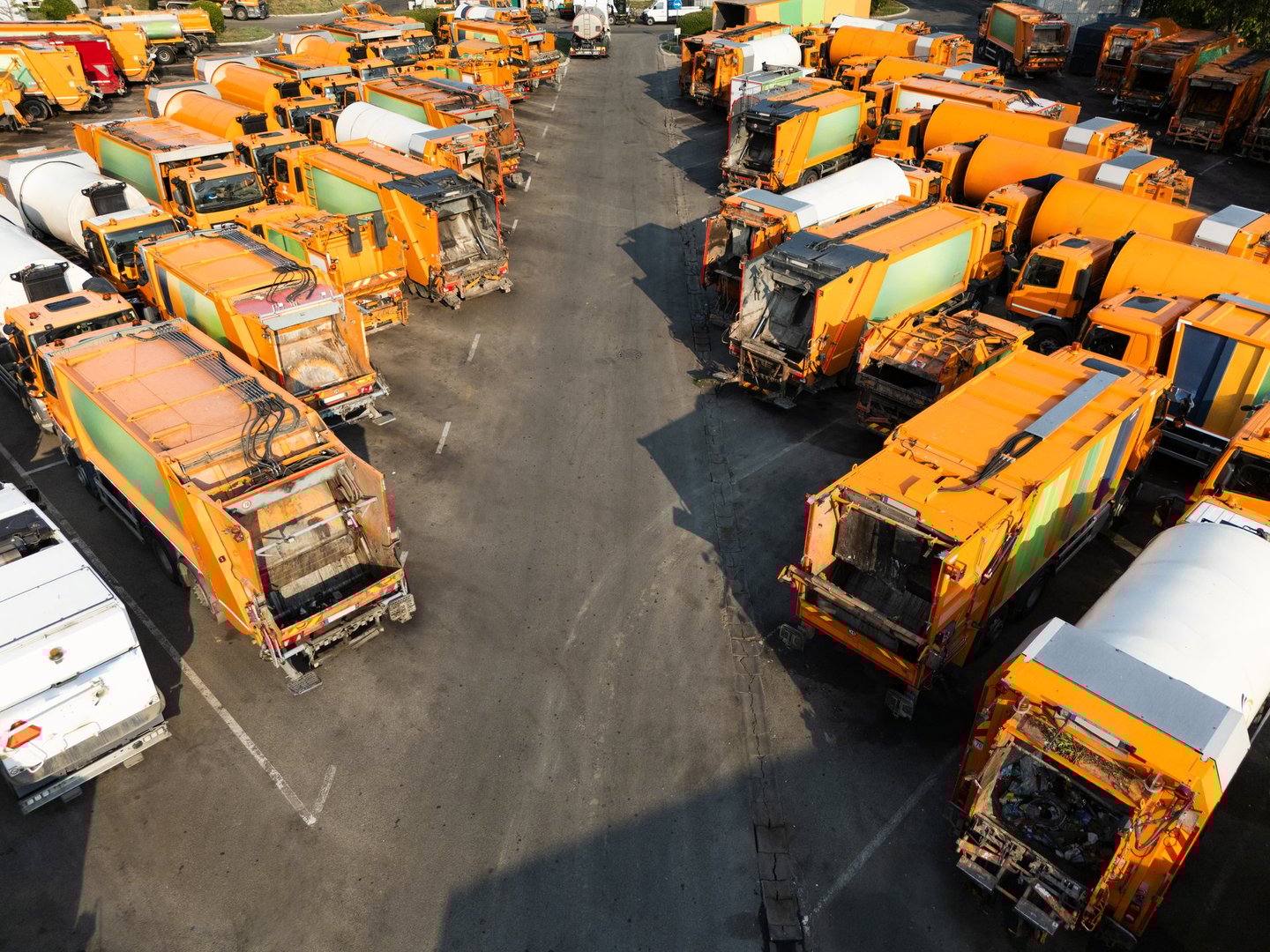 Fleet of yellow garbage trucks. Aerial view