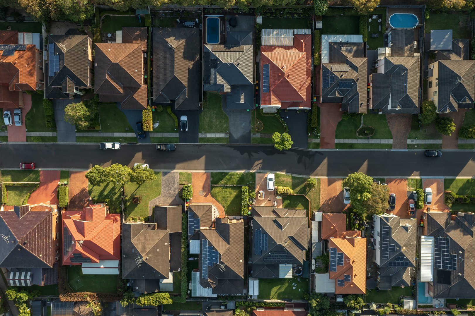 Aerial top-down view of residential roof shingles close-up, high quality drone photography of house rooftop from directly above showing roof texture and details