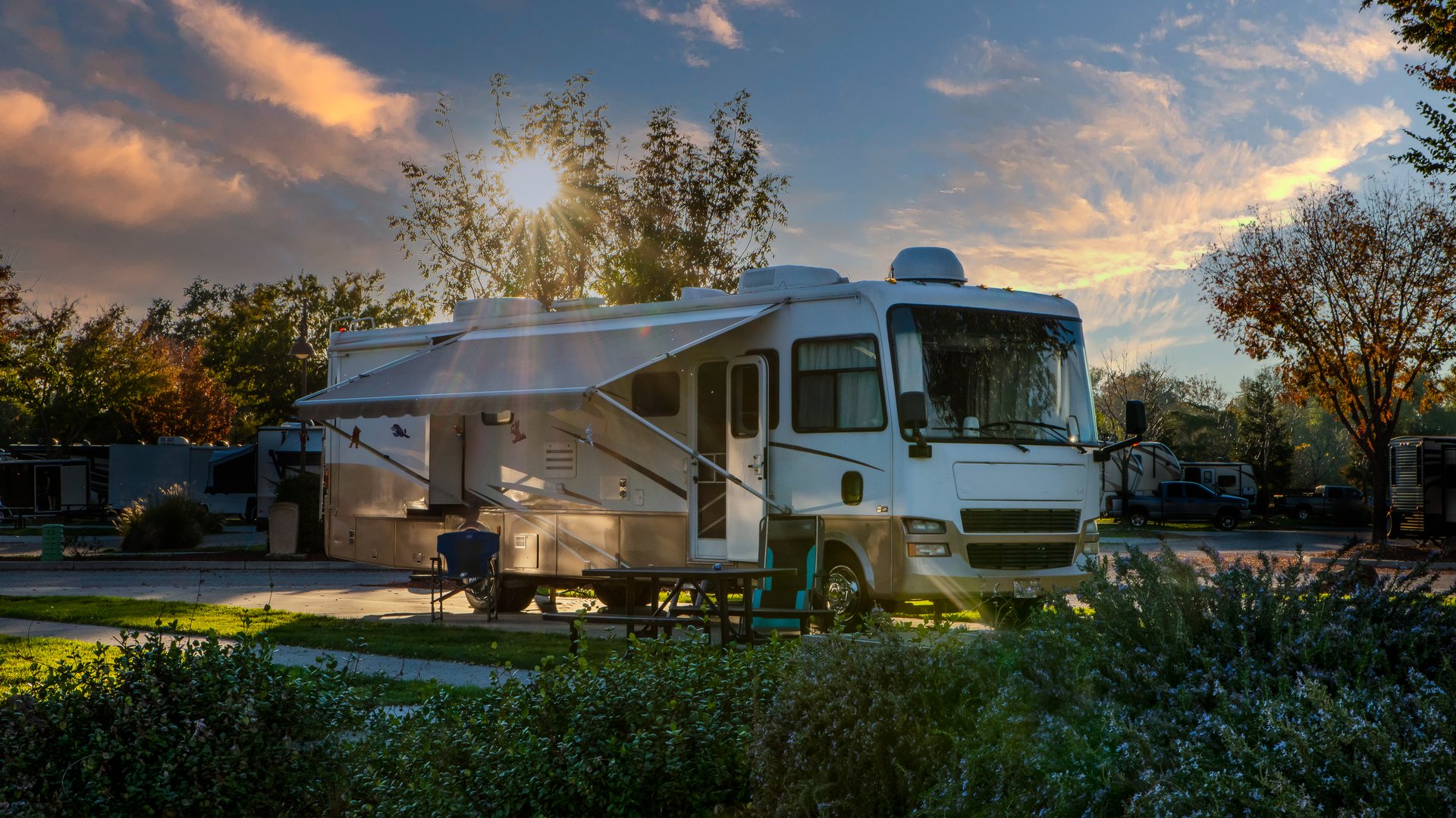 Motorhome parked with a beautiful sunburst above the roof