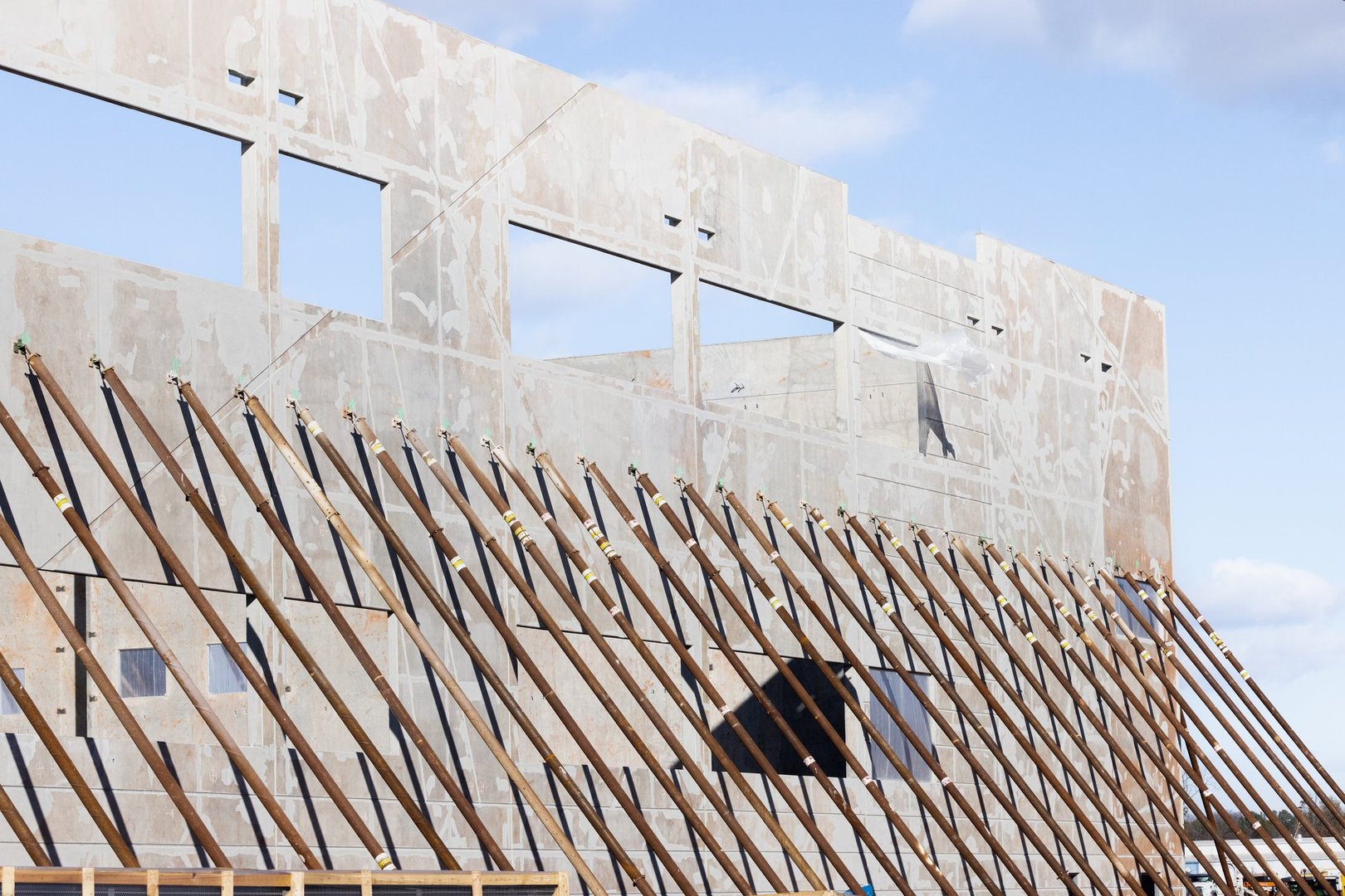 Rows of Shoring or lally columns temporarily bracing concrete walls of data center under construction