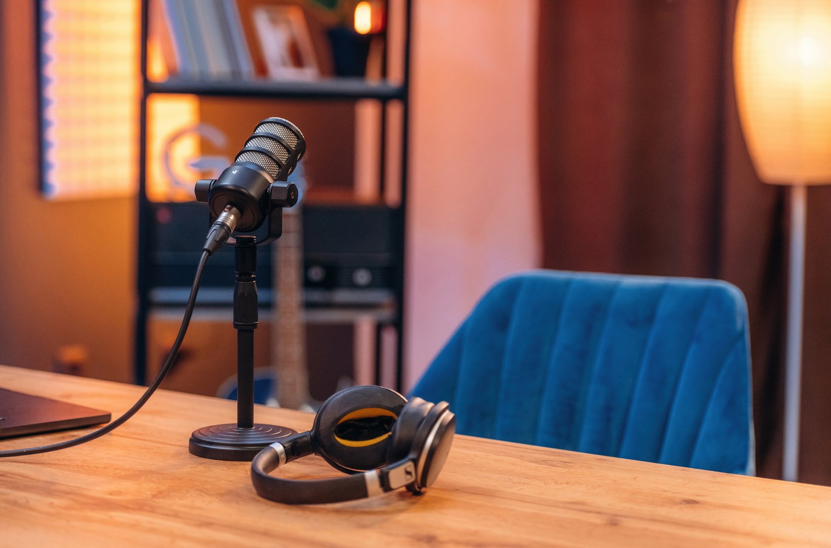 Microphone and headphones are on the table, room for podcasts.