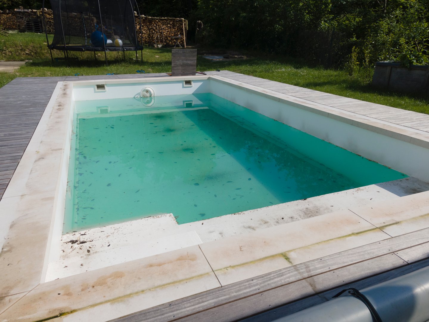 aerial drone photo of pool after winter, cleaning the plane, the pool, draining the dirty water, dirty pool before the spring