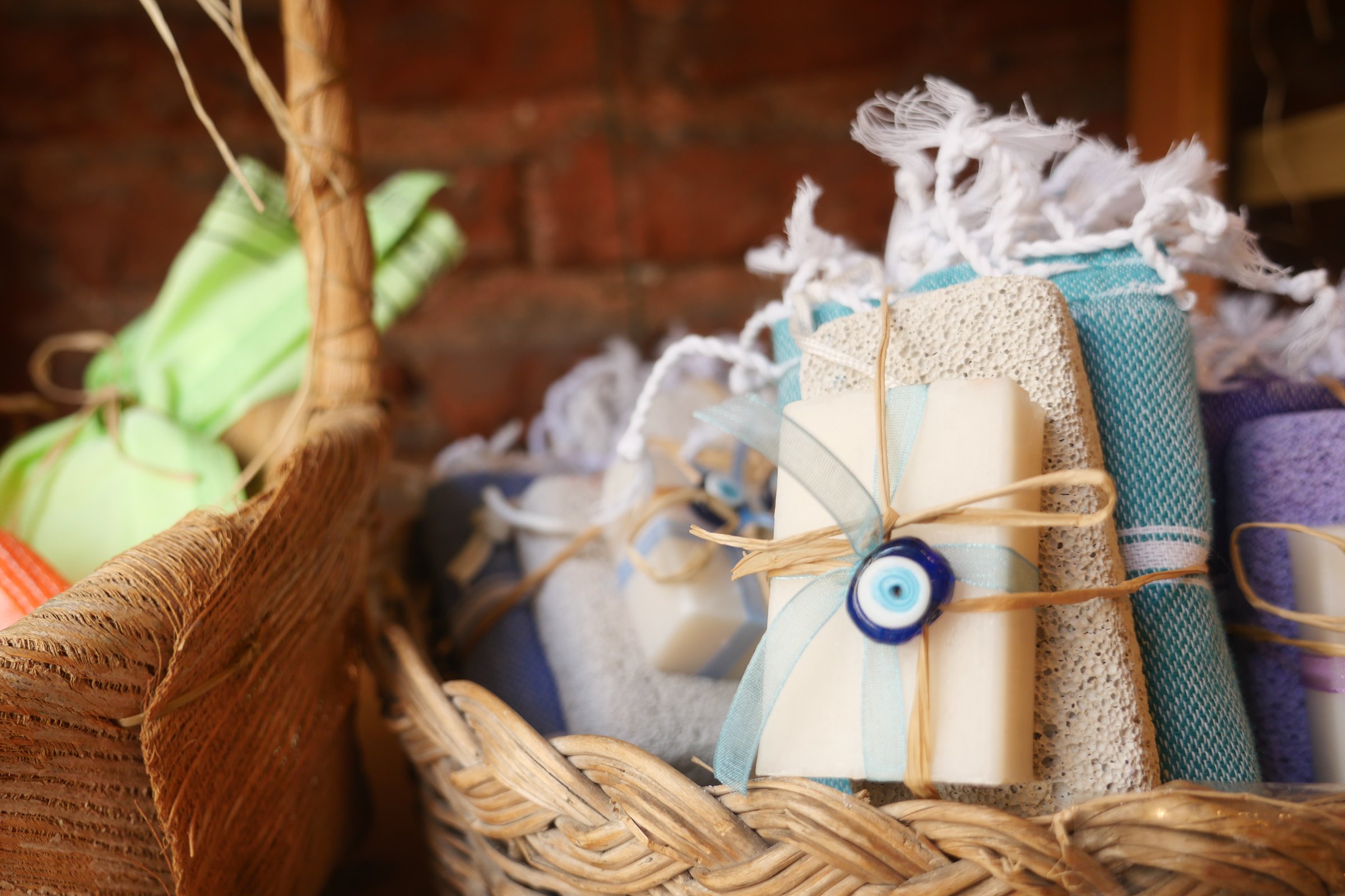 Beautifully arranged handmade soap bars and folded towels, wrapped with ribbon for a charming display.