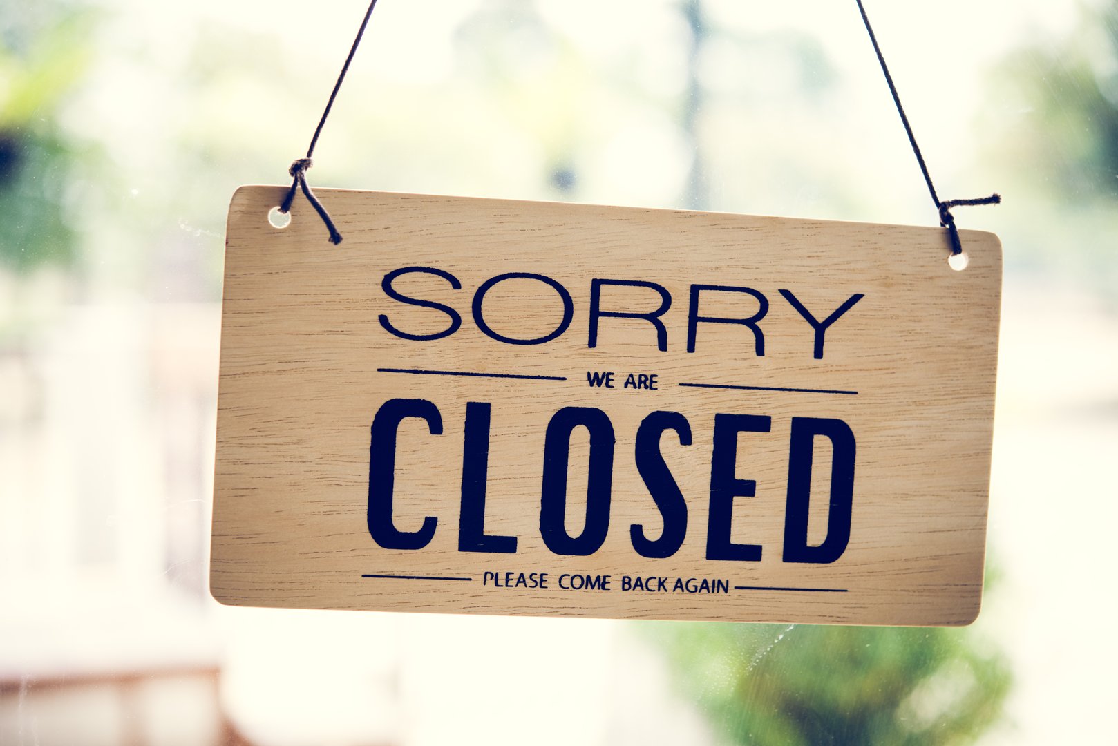 Sorry We Are Closed sign in shop window due to pandemic