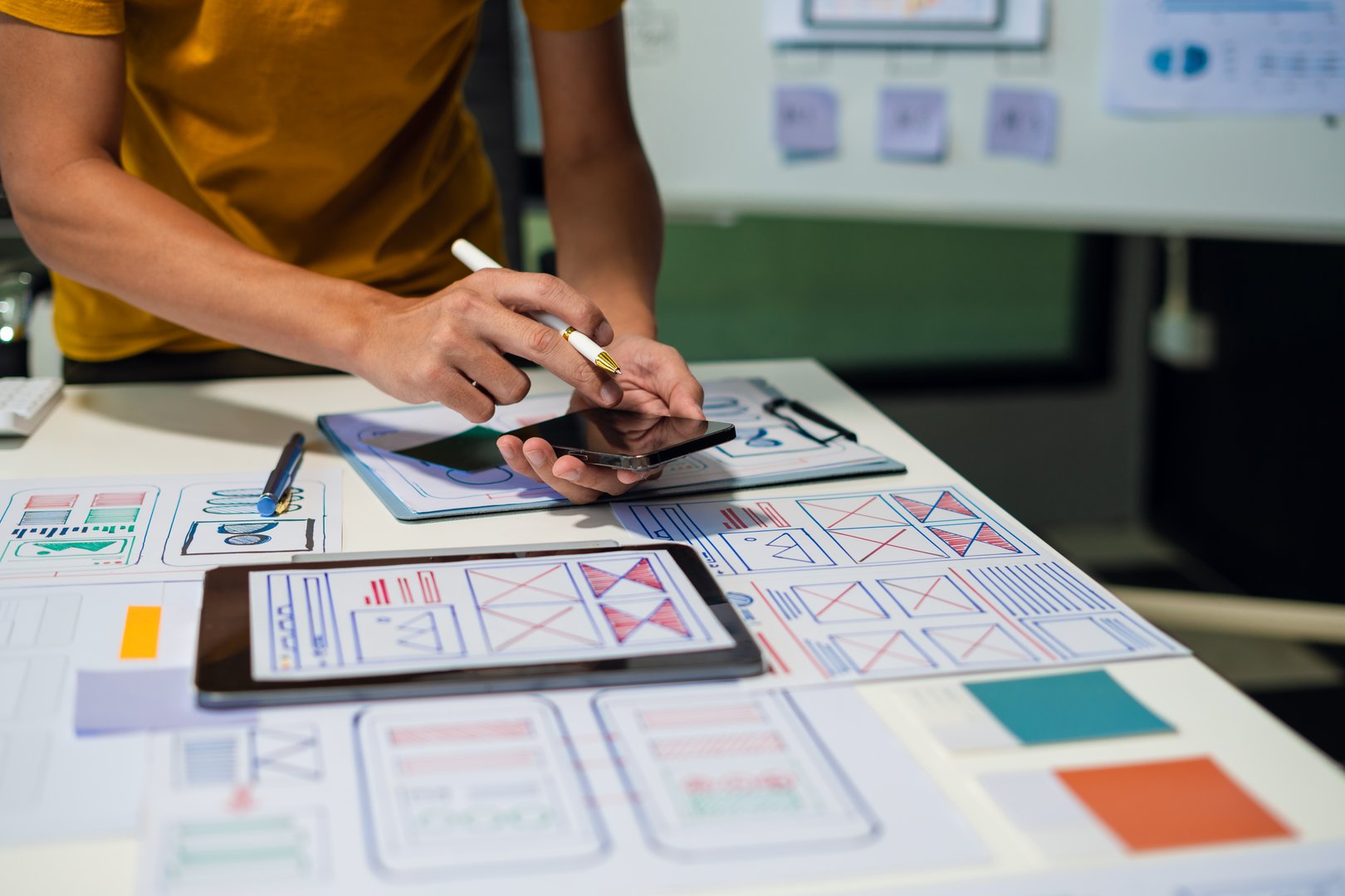 UX developer and ui designer brainstorming about mobile app interface wireframe design with customer breif and color code, User experience concept.