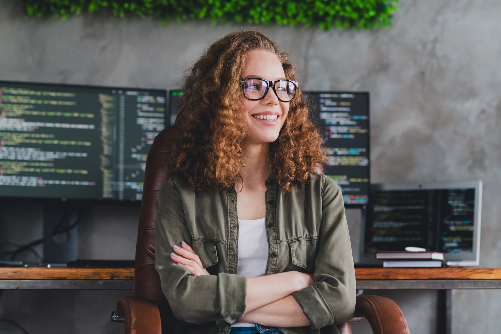 Photo of dreamy confident pretty woman software developer sitting armchair comfortable office workspace workstation indoors.