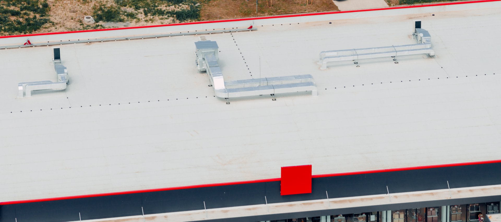 Aerial view of a newly installed pvc membrane roof protecting the hvac system on top of a commercial building