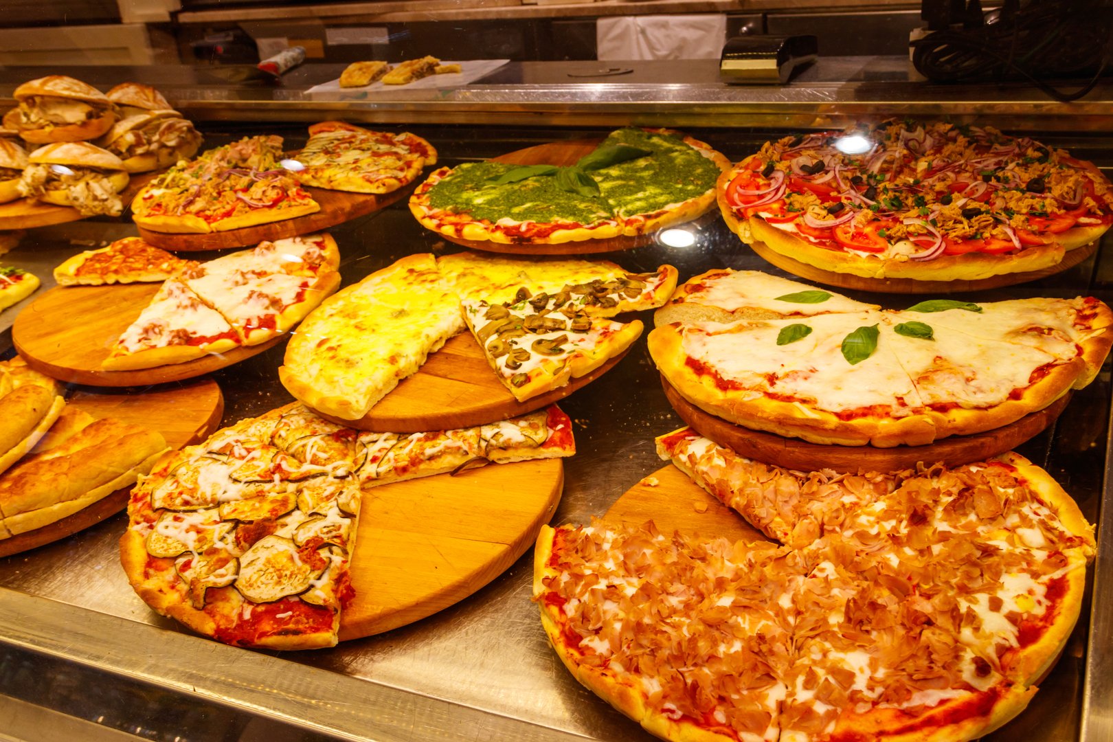 Assortment of italian pizza in the showcase of pizzeria