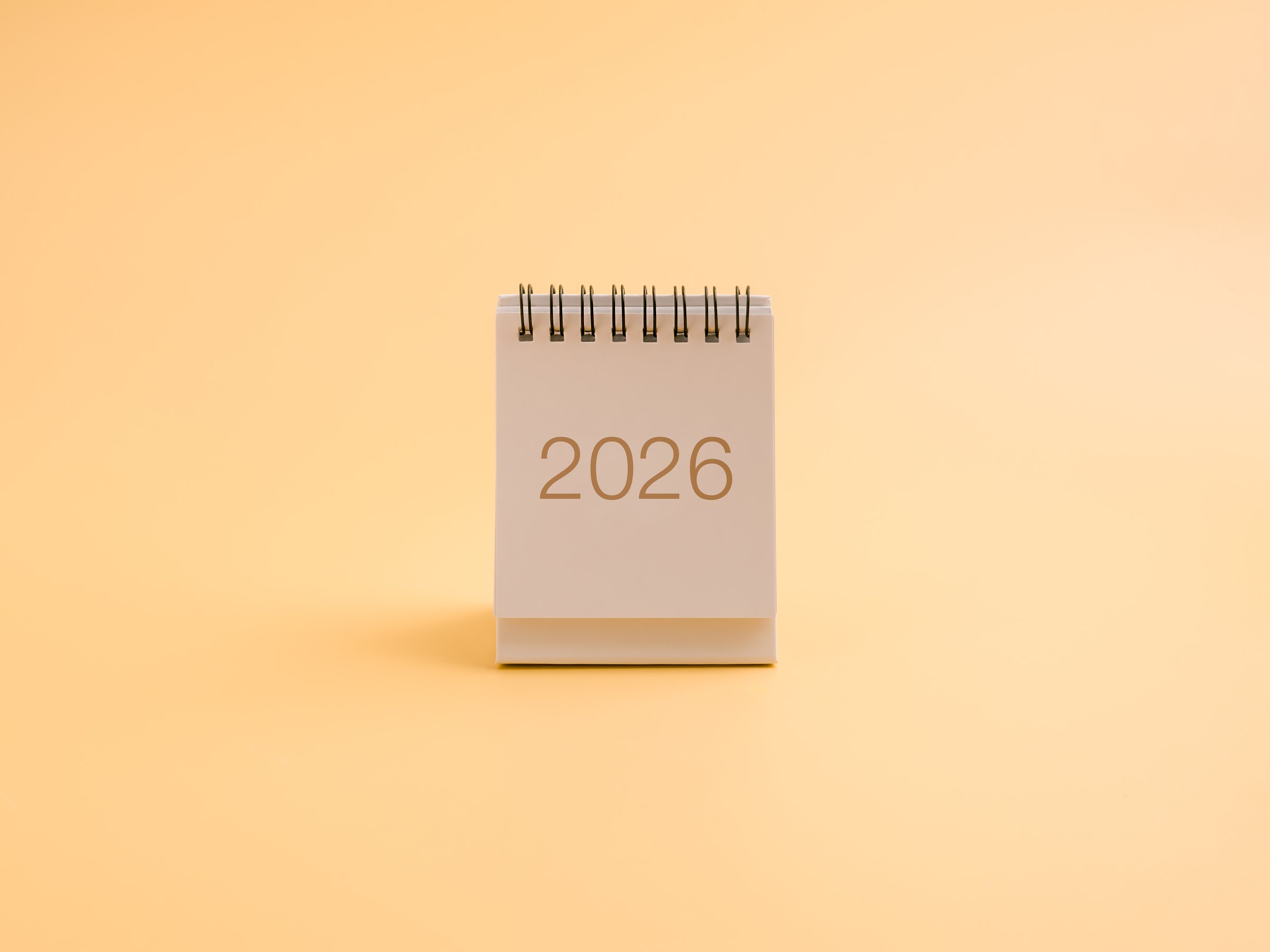 Minimal desk calendar showing year 2026 on soft pastel background. Concept of new year, fresh start, future planning, goal setting, annual resolutions, and time management for upcoming success.