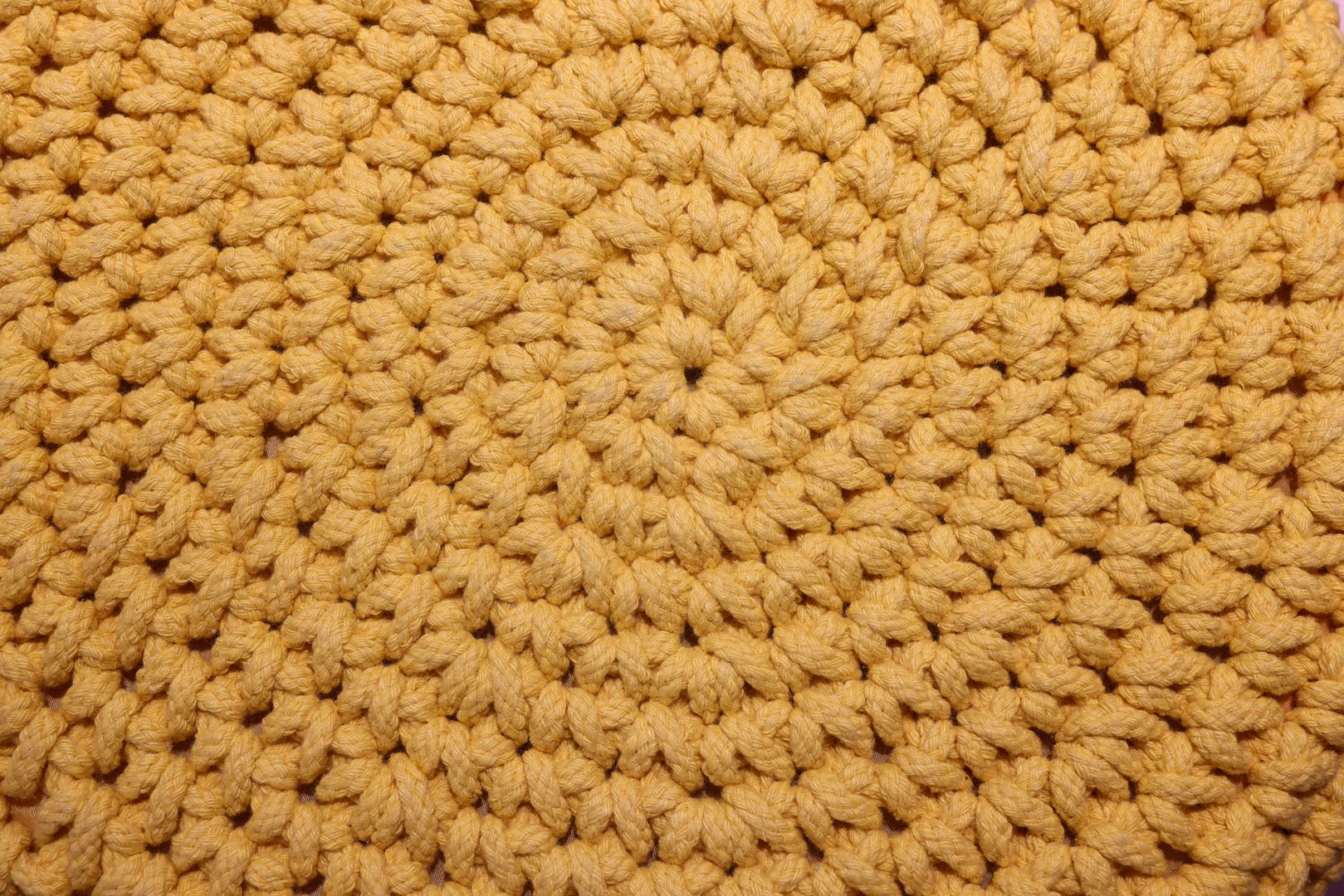 This is a detailed closeup view of a textured yellow crochet pattern, which is simply ideal for home decor inspiration