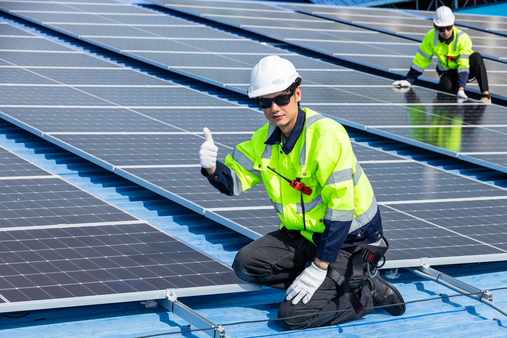Professional Engineer Service Solar Panel. Worker Maintenance Cleaning Replacing Solar Panel. Solar photovoltaic panel system in Industry roof. Saving Energy with Clean Power.