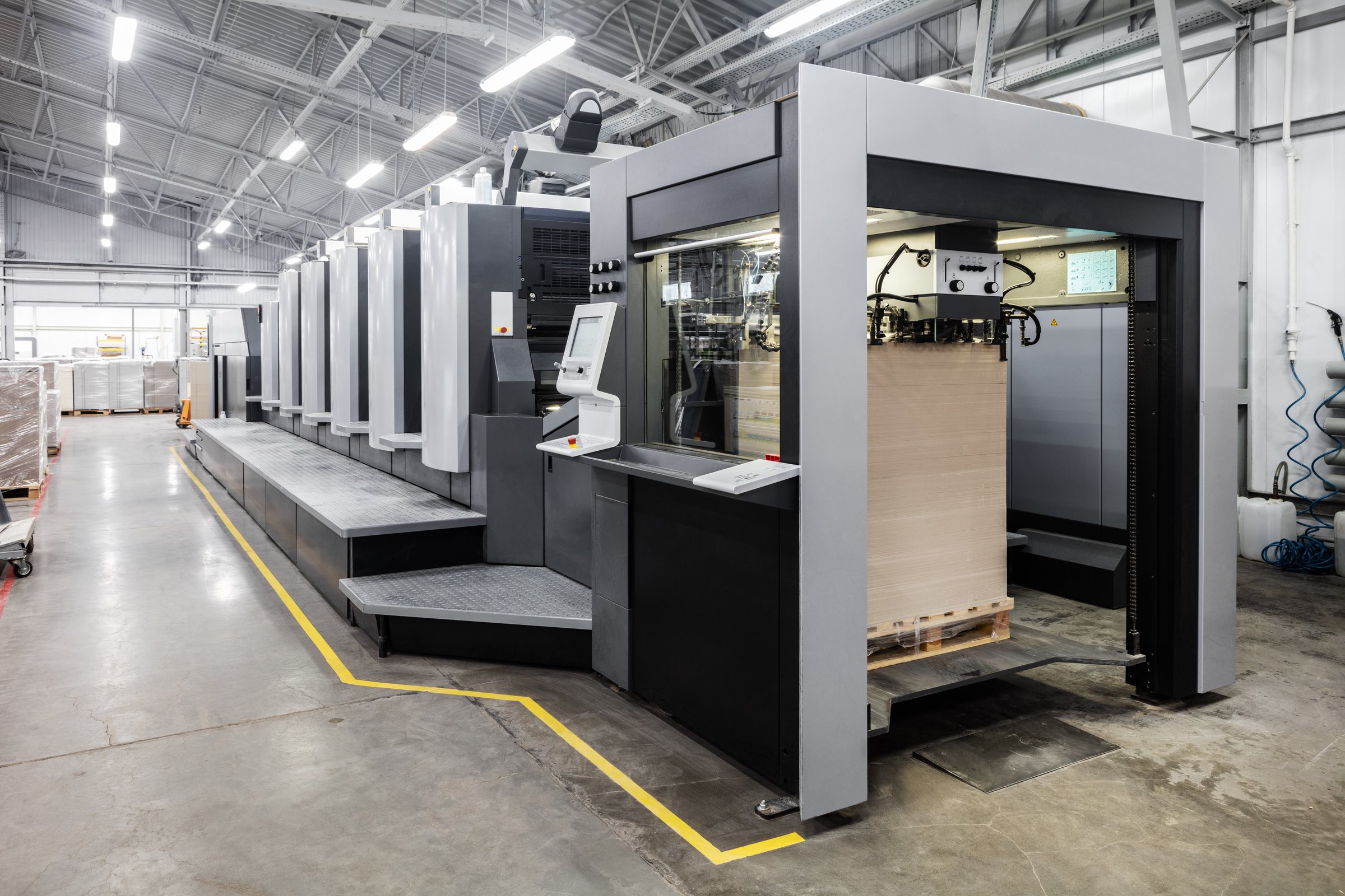 Offset printing machines. Large printing machine perspective. printing machine cylinders and printing ink pot. Offset machine. Offset press is a printing machine designed to produce fine quality