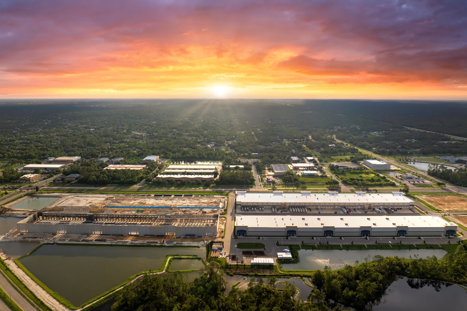 Industrial warehouse construction site. Assembling of metal and concrete frame of new logistics center in North Port, Florida.