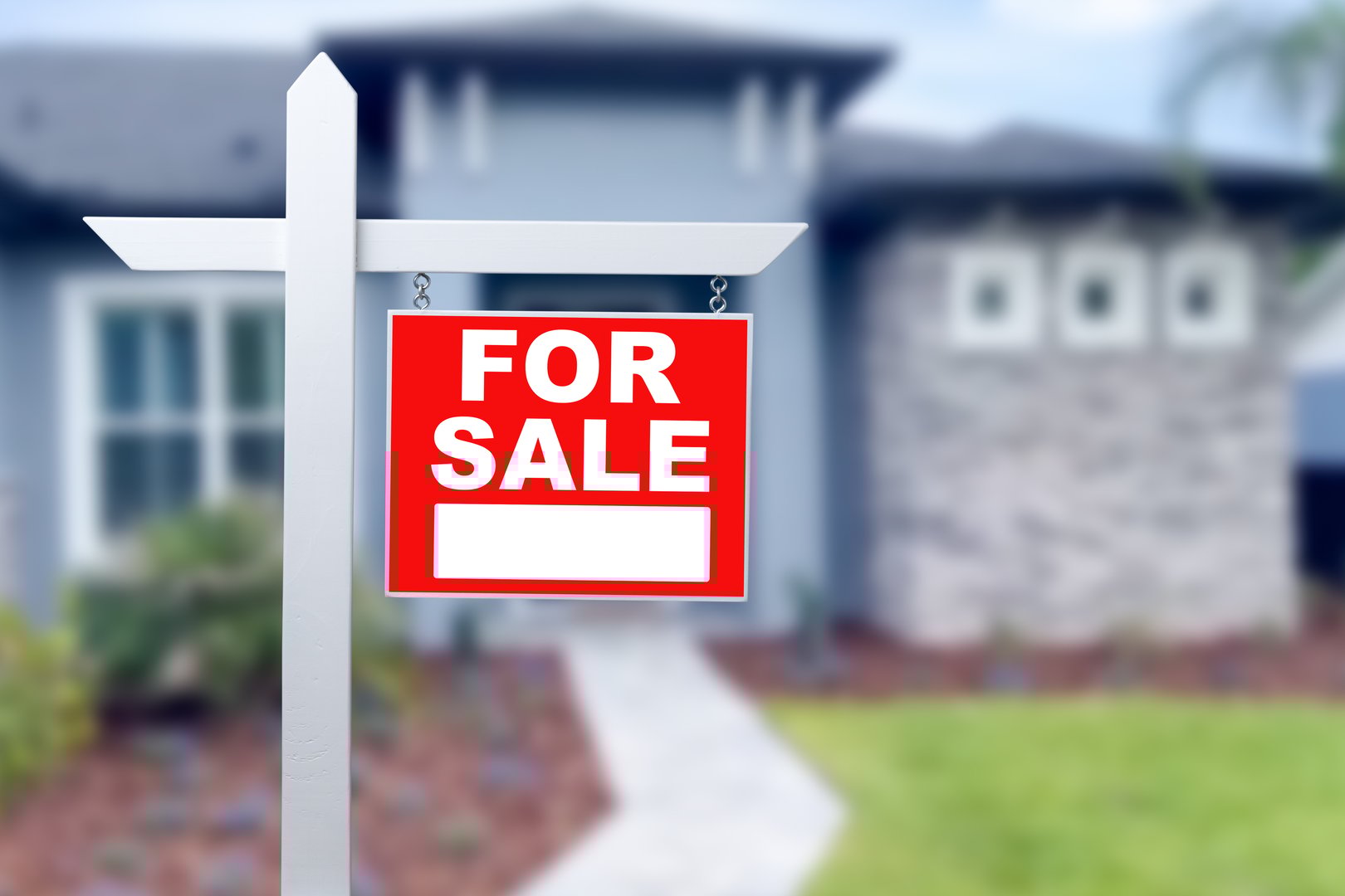Home For Sale Real Estate Sign and Beautiful New House